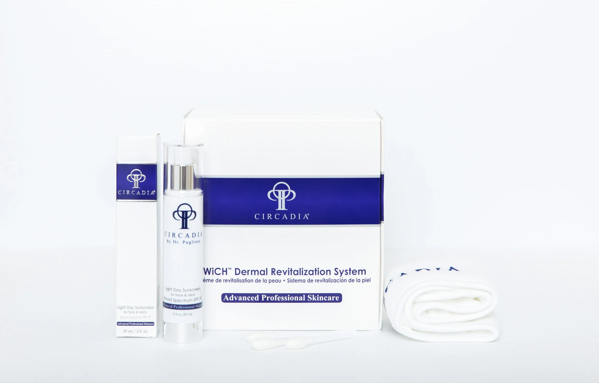 A skincare product kit featuring Circadia branded items, including a bottle of sunscreen, a boxed product, and a rolled white towel, all arranged against a white background.