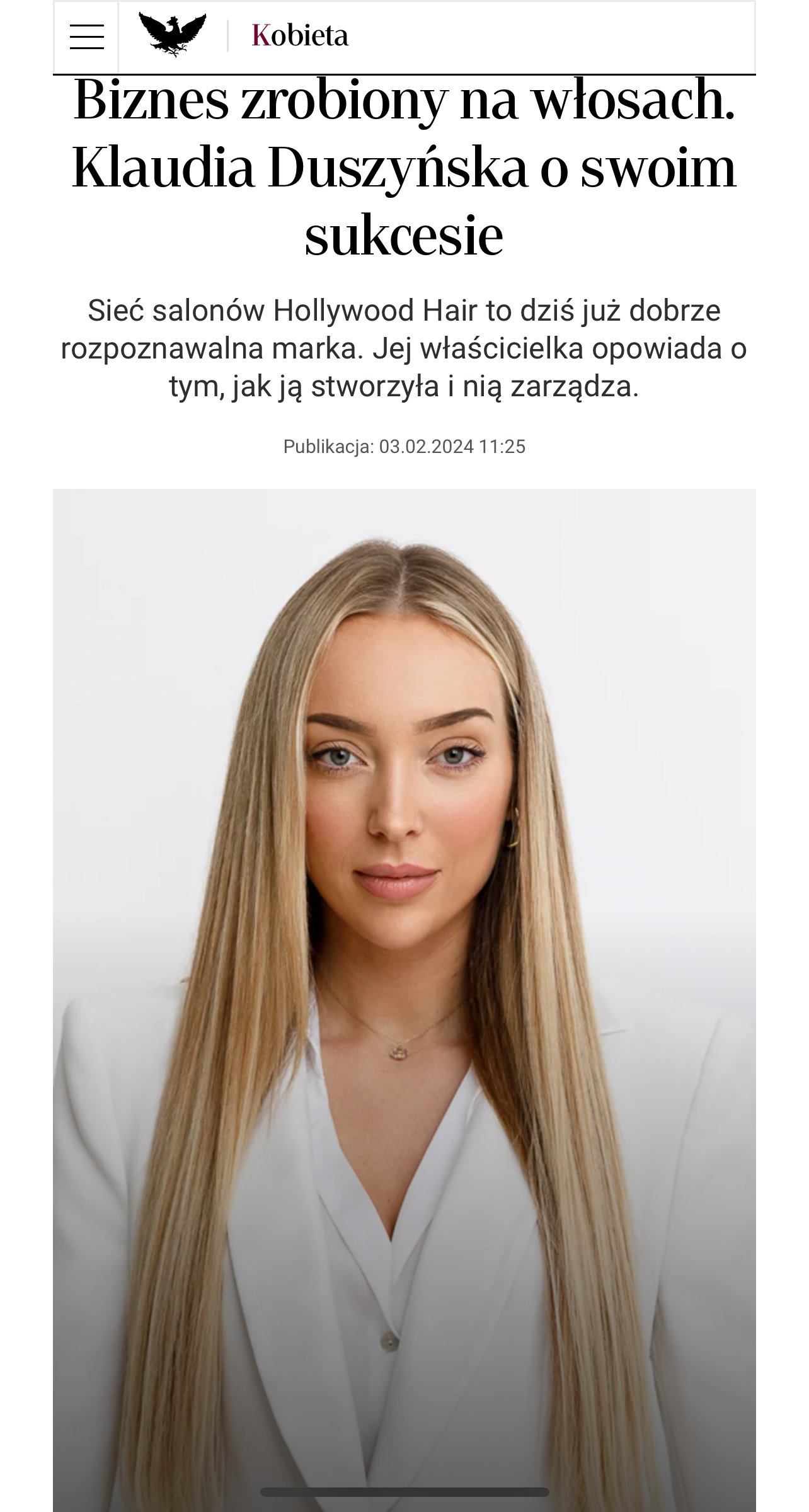 A close-up photograph of a young woman with long blonde hair, wearing a white blazer, against a plain white background.