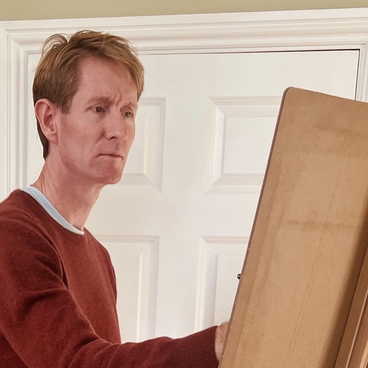 Photo of artist, Keith Wright, stood at the easel