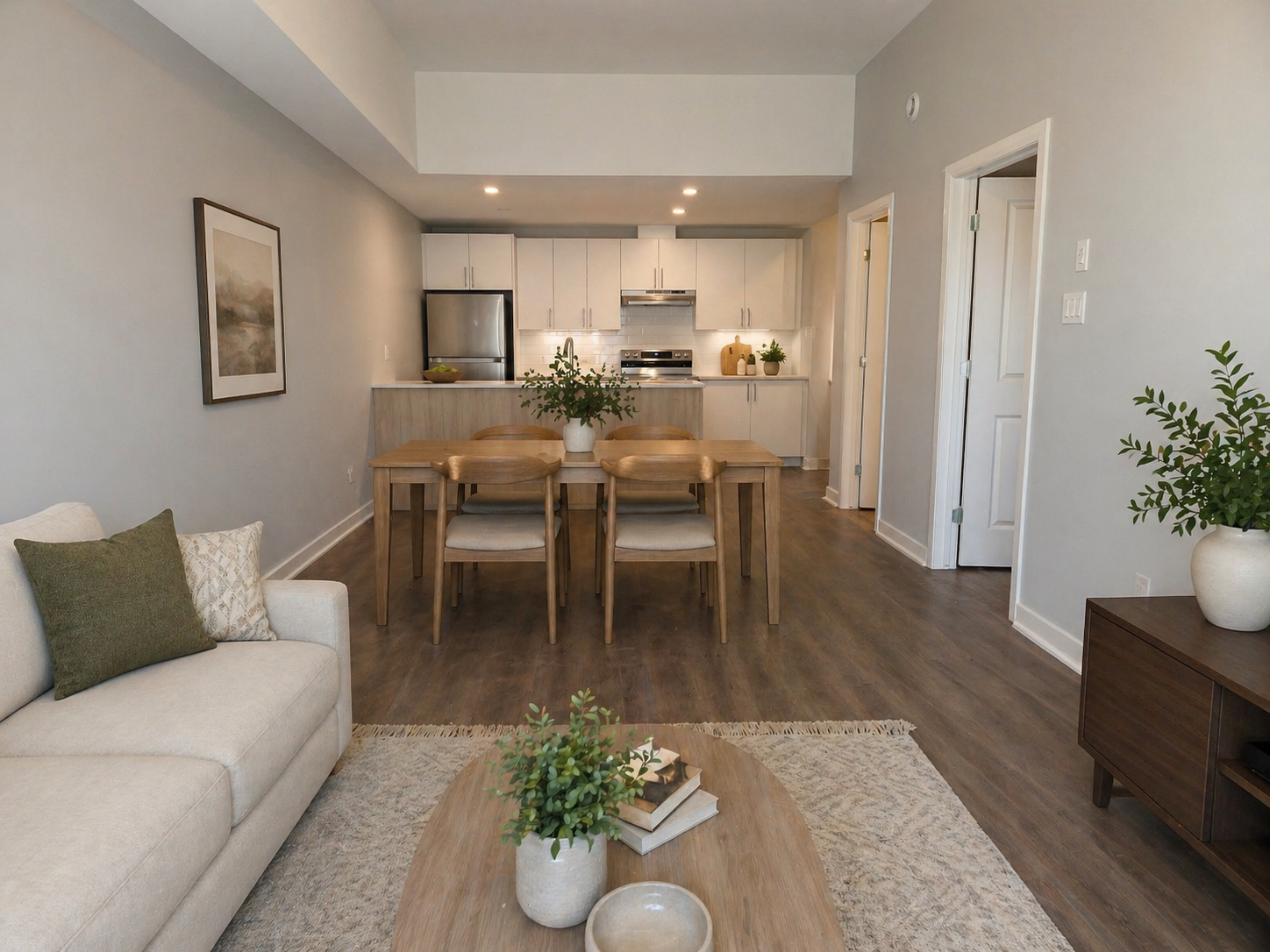 Open-concept furnished dining and living space.