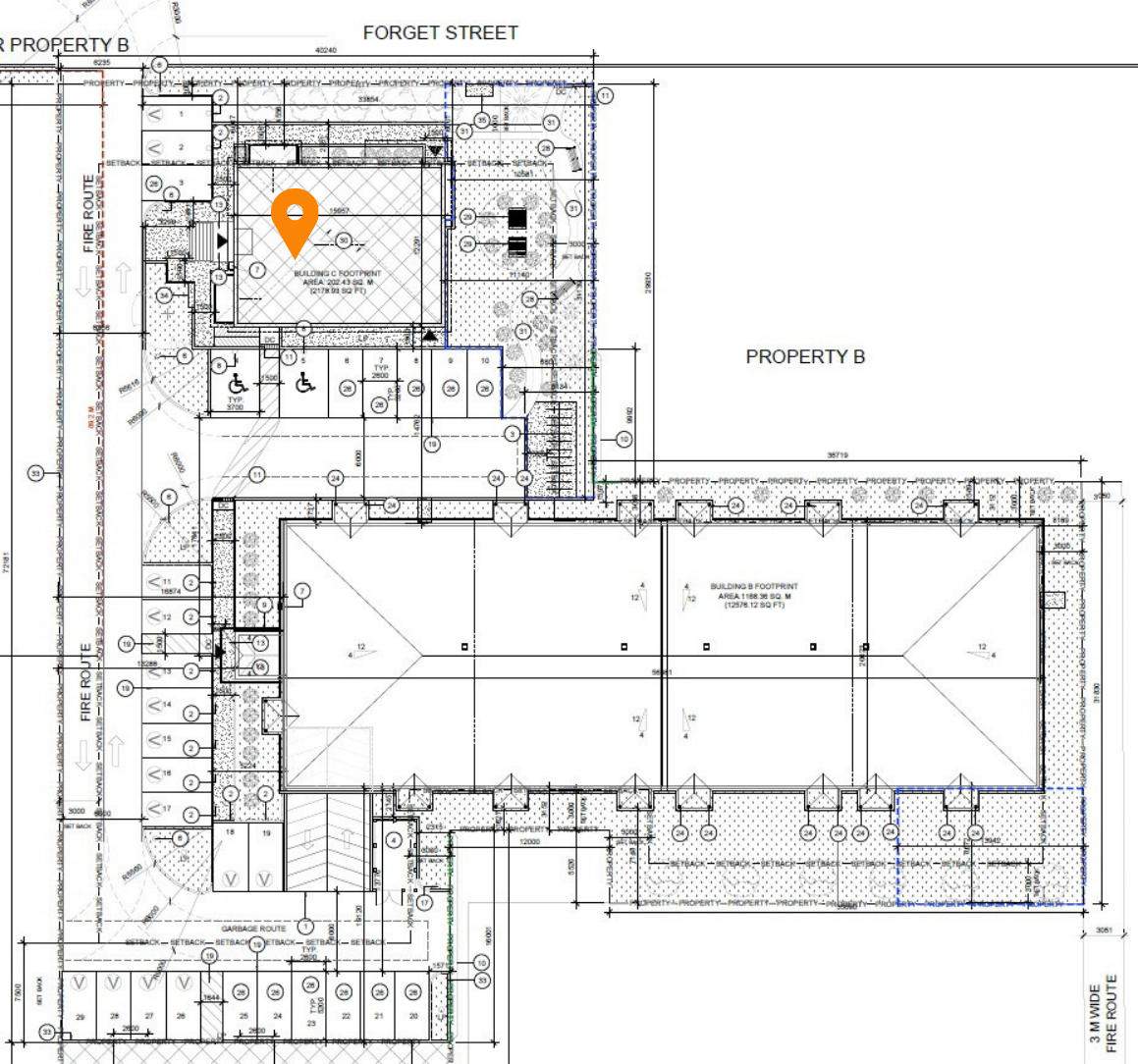 Architectural site plan of a property with building footprints, parking areas, landscaping, and utility details, including street names and measurements.