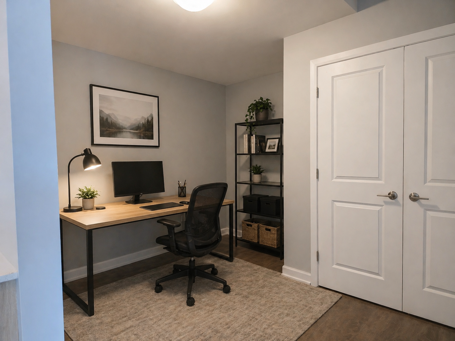 Furnished office space with desk, chair and computer.