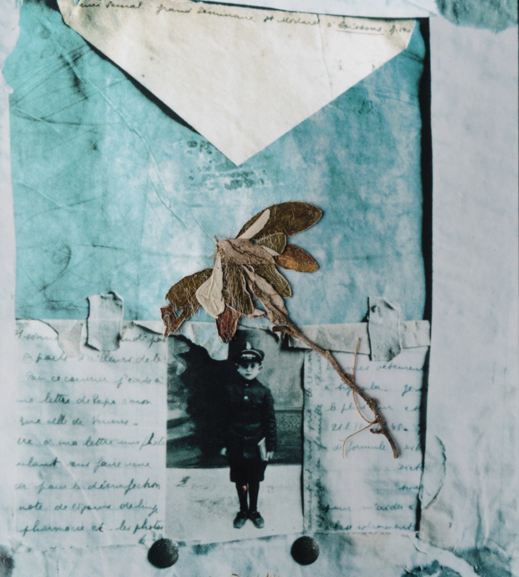 A collage with an old photograph of a young person in a hat and coat, handwritten notes, torn paper, and a dried leaf arranged on a blue textured background.