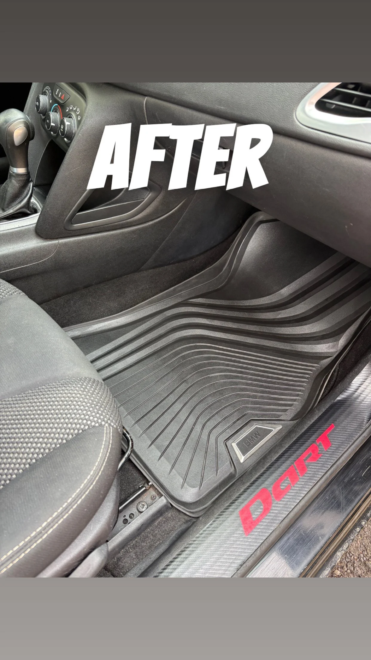 Black car floor with rubber mat, part of a seat, and a door sill with 'DART' in red lettering.