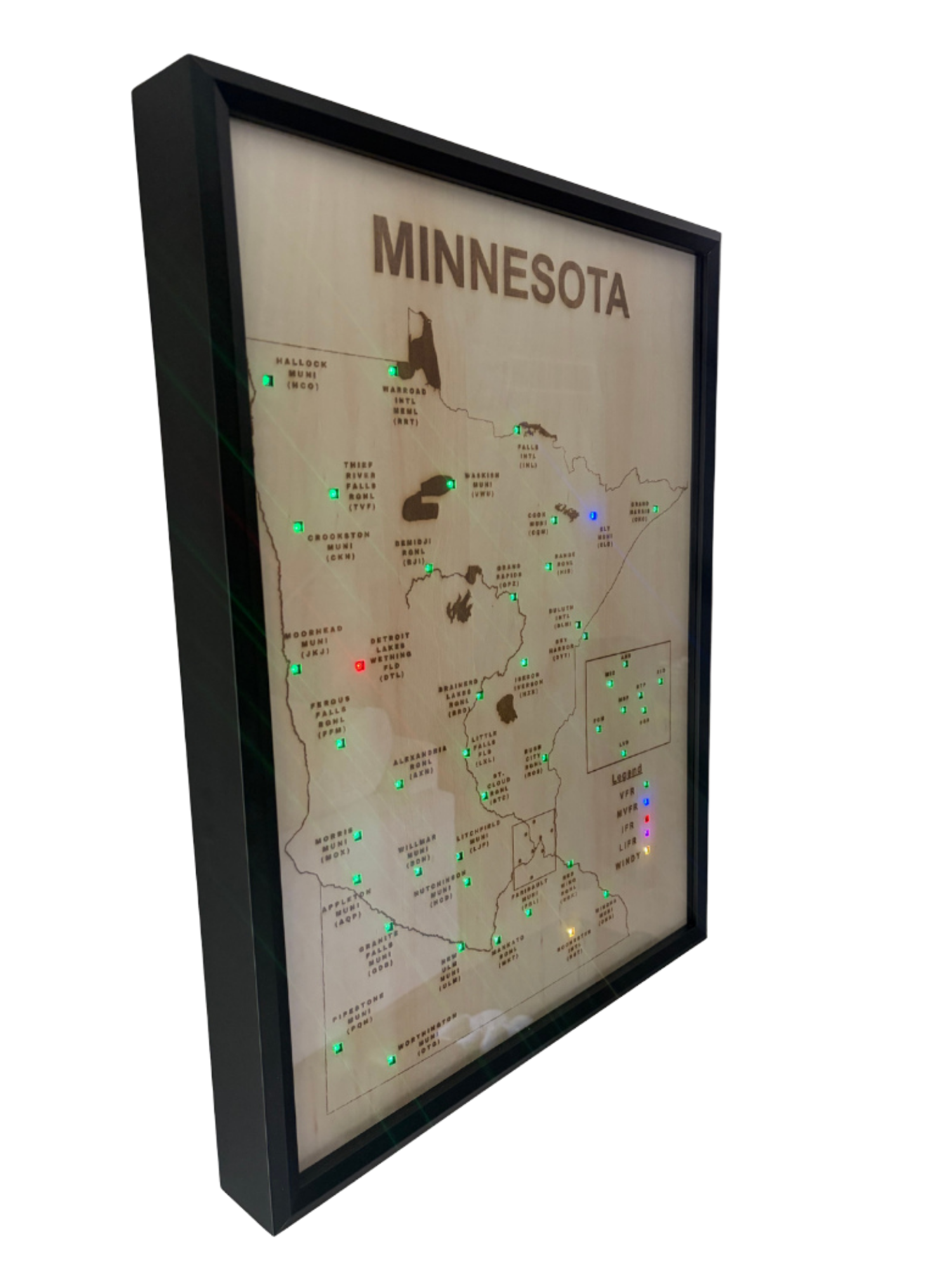 A framed map of Minnesota with various city labels and colored LED indicator lights.