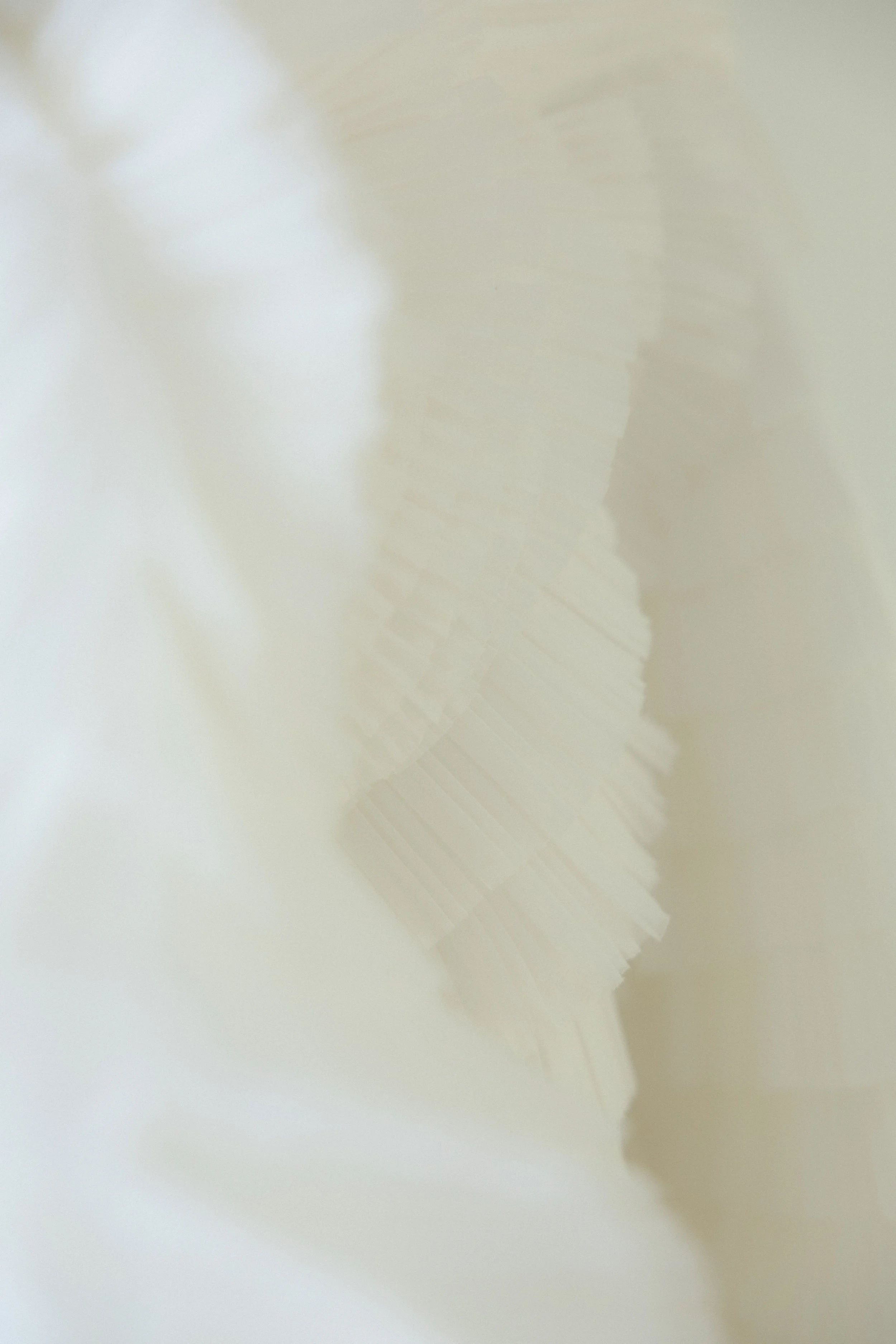Close-up of a white, textured, paper or fabric surface with a faint pattern. Love Letty Content, Luxury Wedding Content Creation in Dallas Texas.