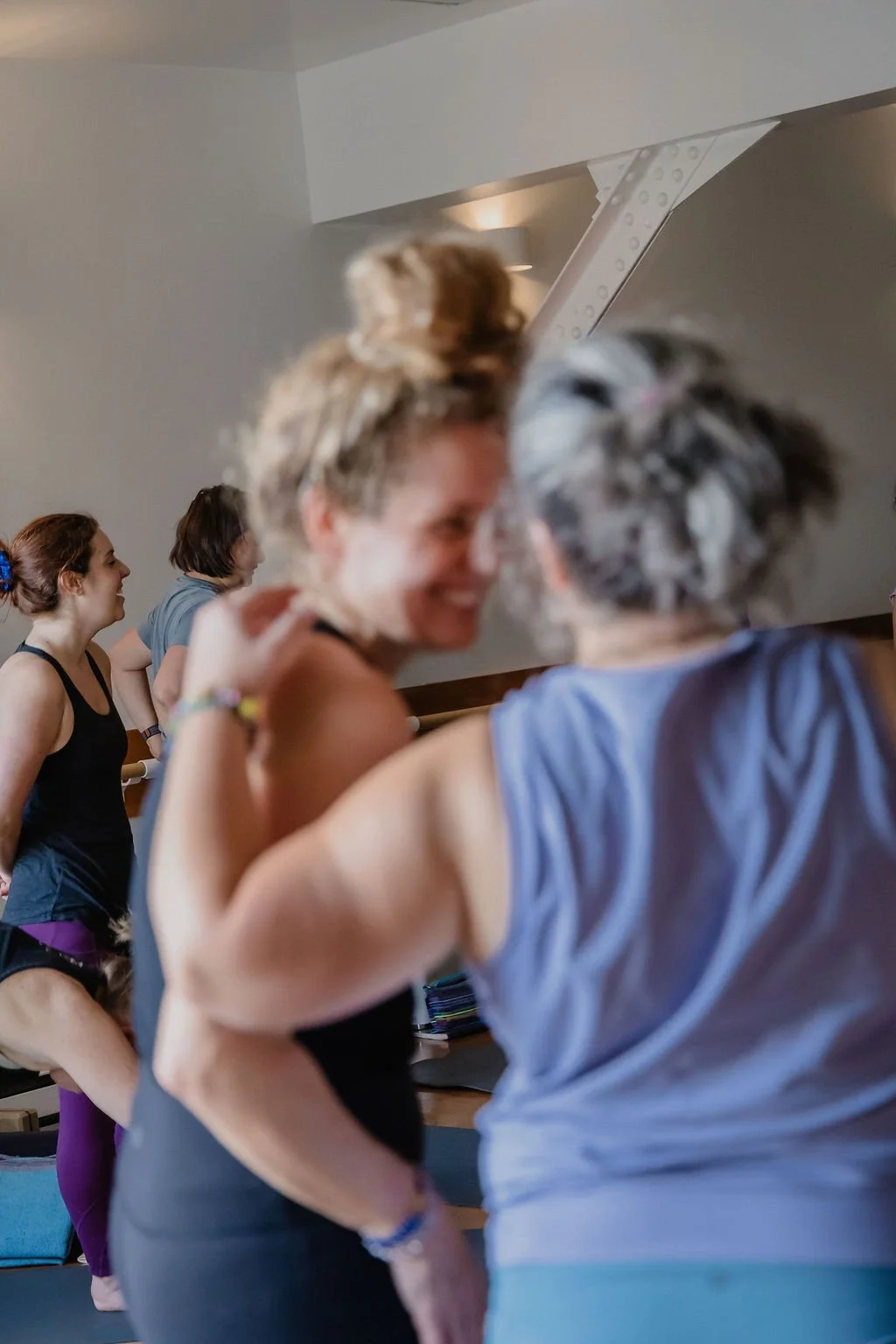 Women laughing in a Montreal yoga studio