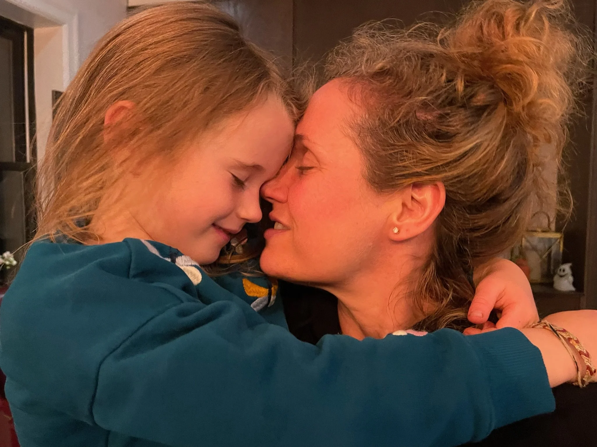 Mom and small child touching noses