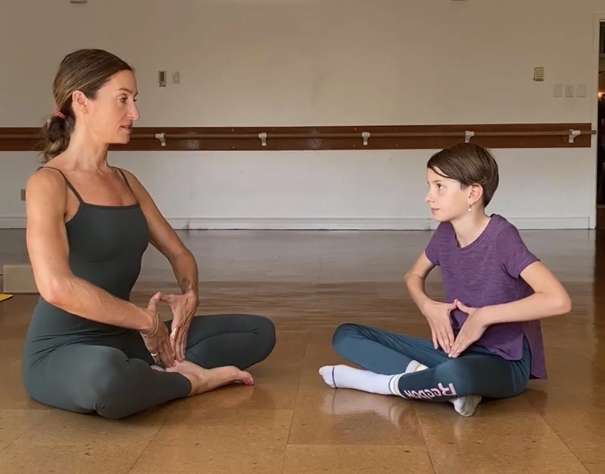 Mother and child practicing kundalini yoga and breathwork together