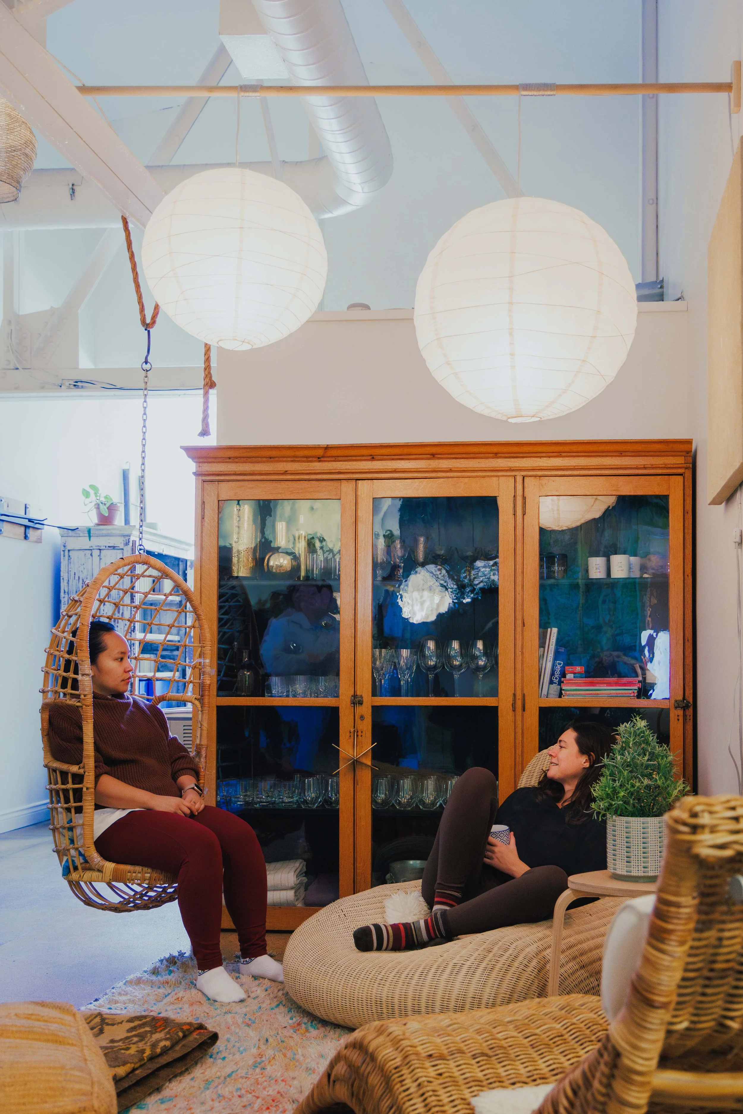 Women sitting and talking in the yoga studio lounge