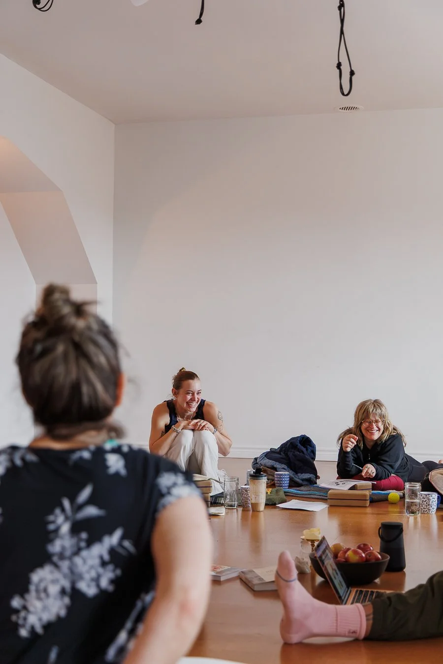 Students laughing in a yoga teacher training