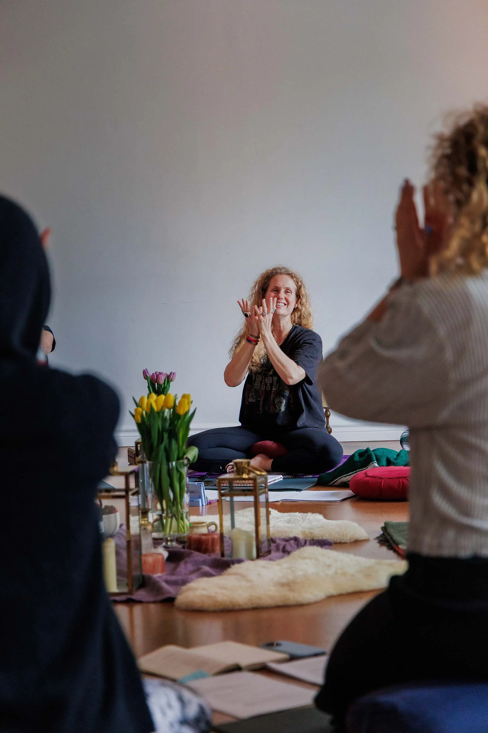 Yoga teacher and students in circle doing kundalini mudra