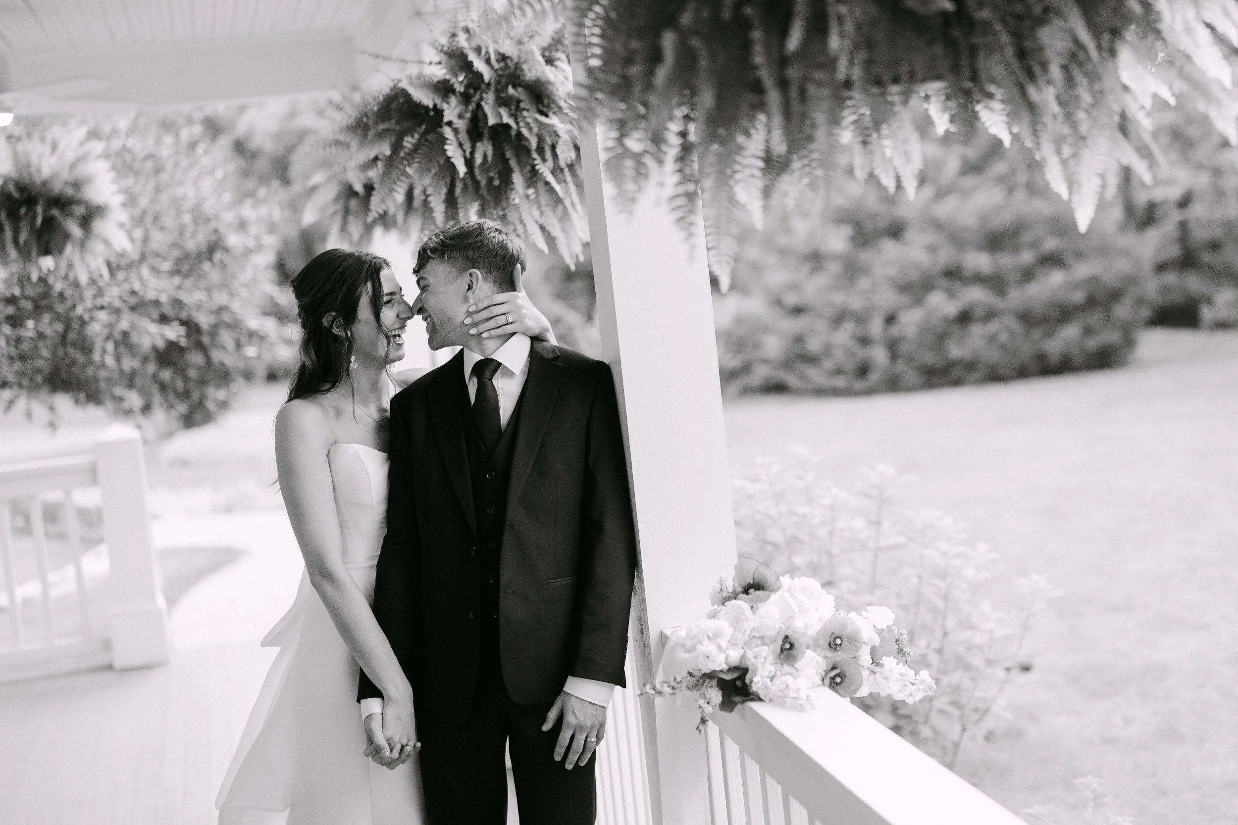 a couples portrait of newlyweds, black and white, on an outdoor vestibule.