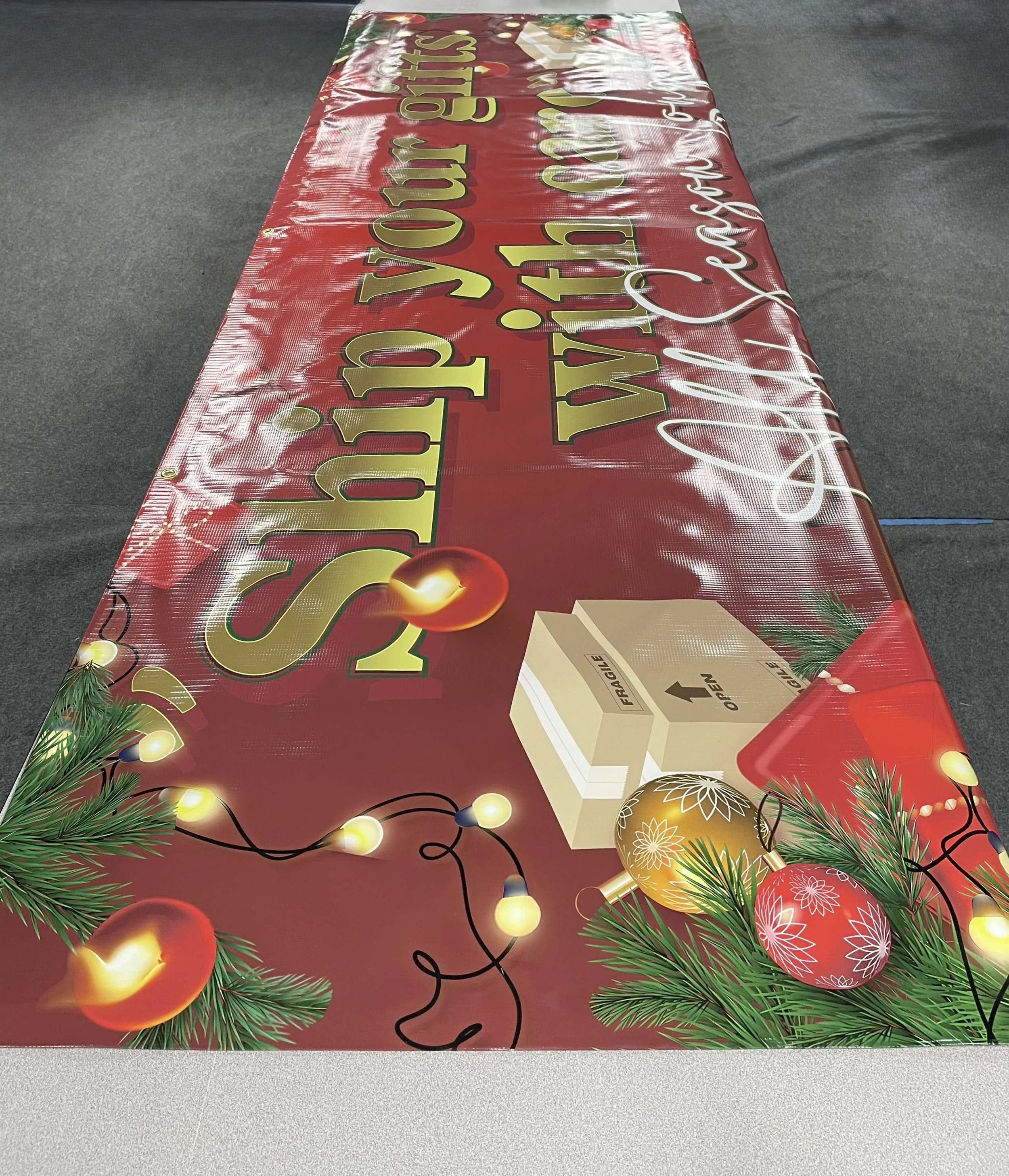 A large, festive holiday-themed table cover with Christmas decorations and message.