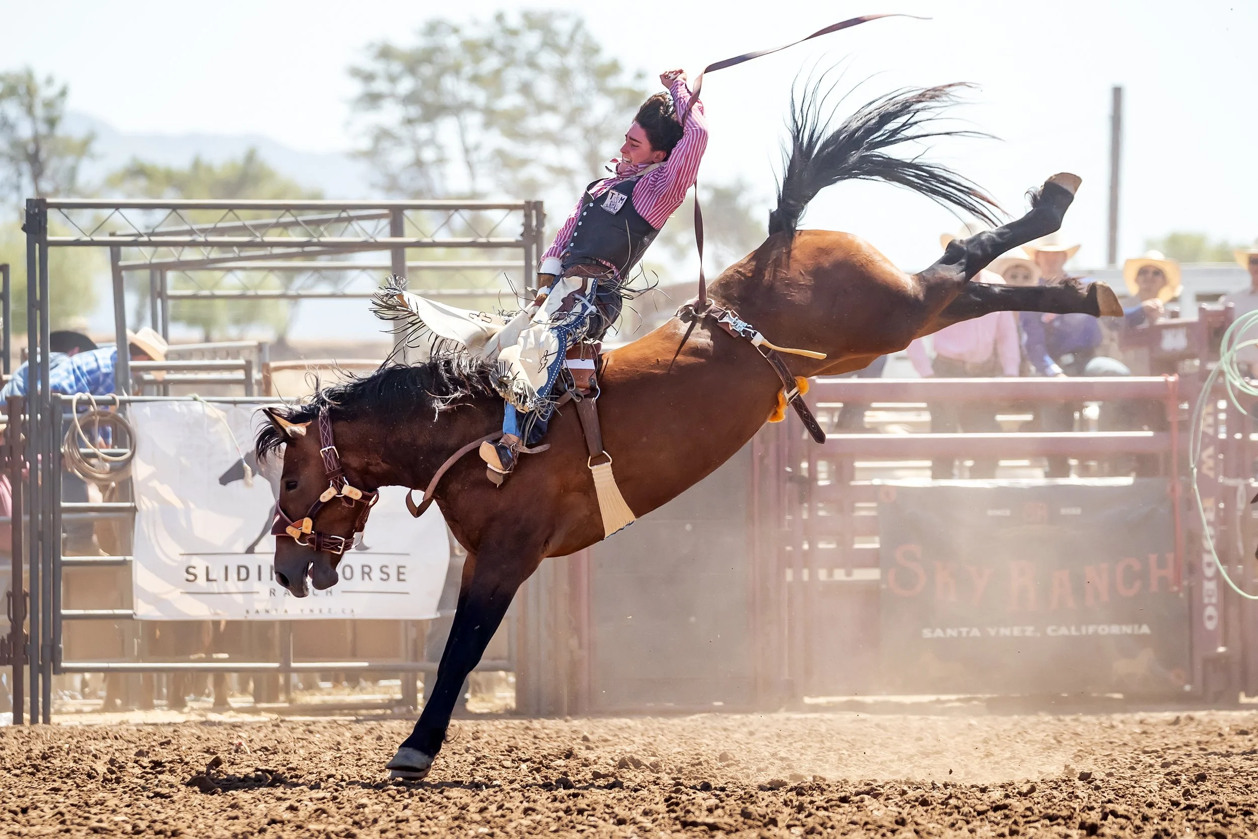 A cowboy riding a bucking horse during a rodeo competition at Sky Ranch in Santa Ynez, California.
