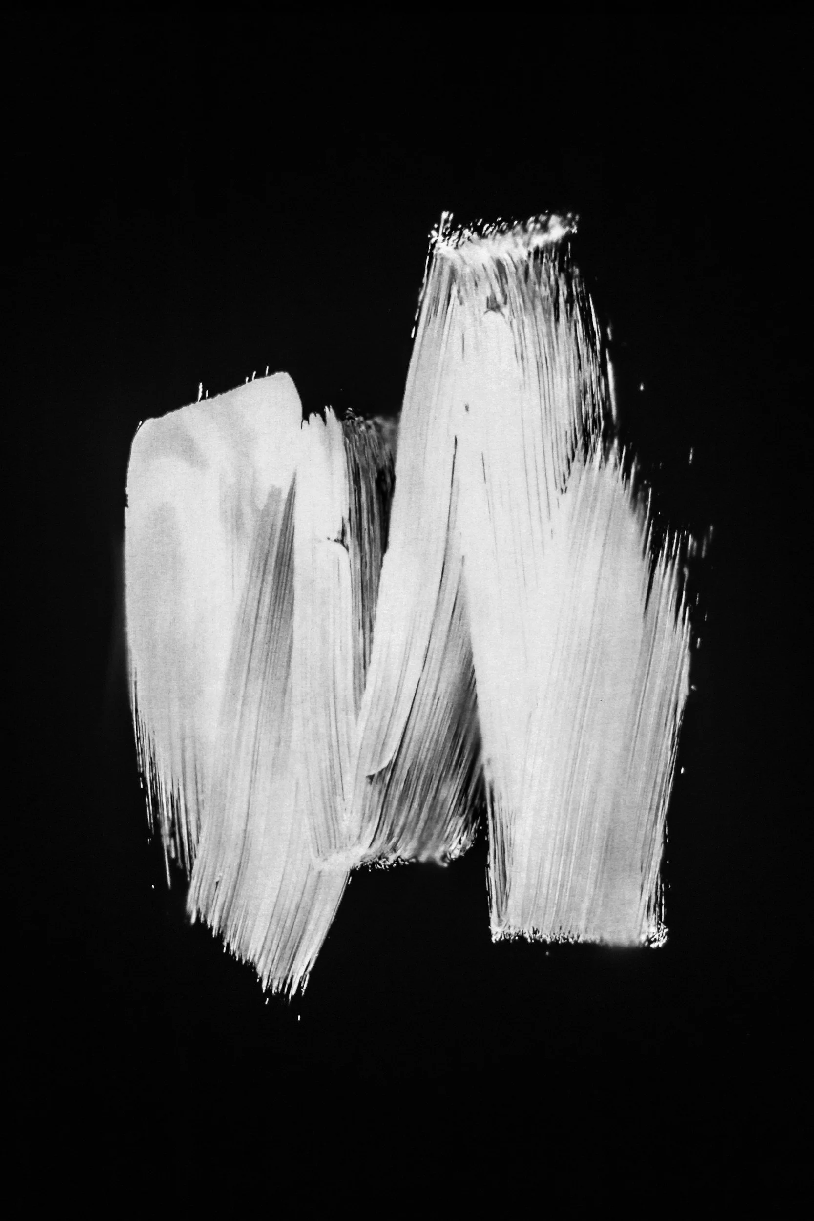 Black and white abstract painting with broad brushstrokes creating two large, vertical, irregular shapes on a dark background.