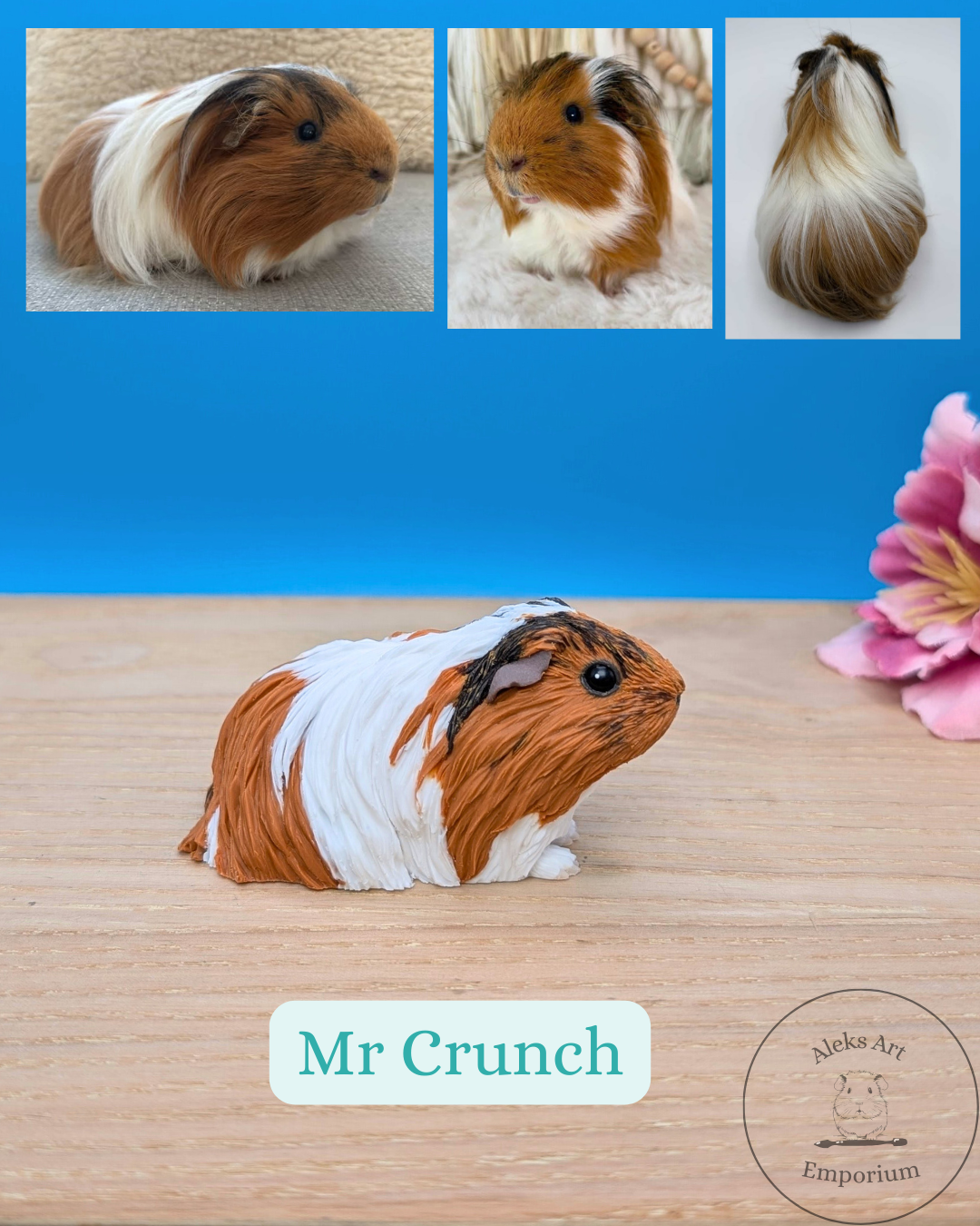 A detailed figurine of a guinea pig named Mr. Crunch, made to resemble a guinea pig, with a mixture of brown, white, and black fur patterns, sitting on a wooden surface. The background is a blue wall, and there is a pink flower on the right side. In 