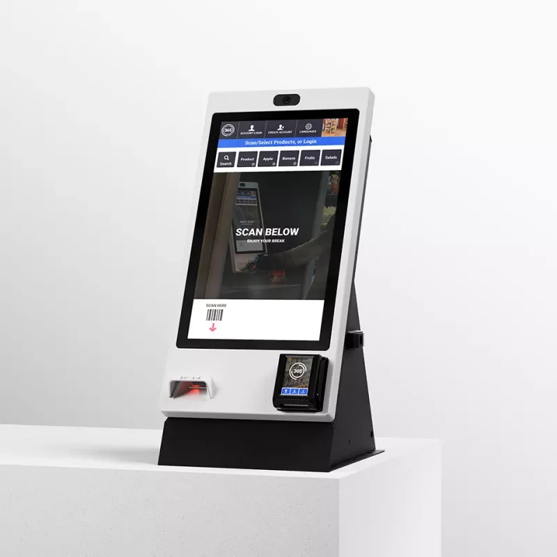A touchscreen self-order kiosk for scanning and pay in retail or food service, showing options for scanning below the screen and a mobile device docked.