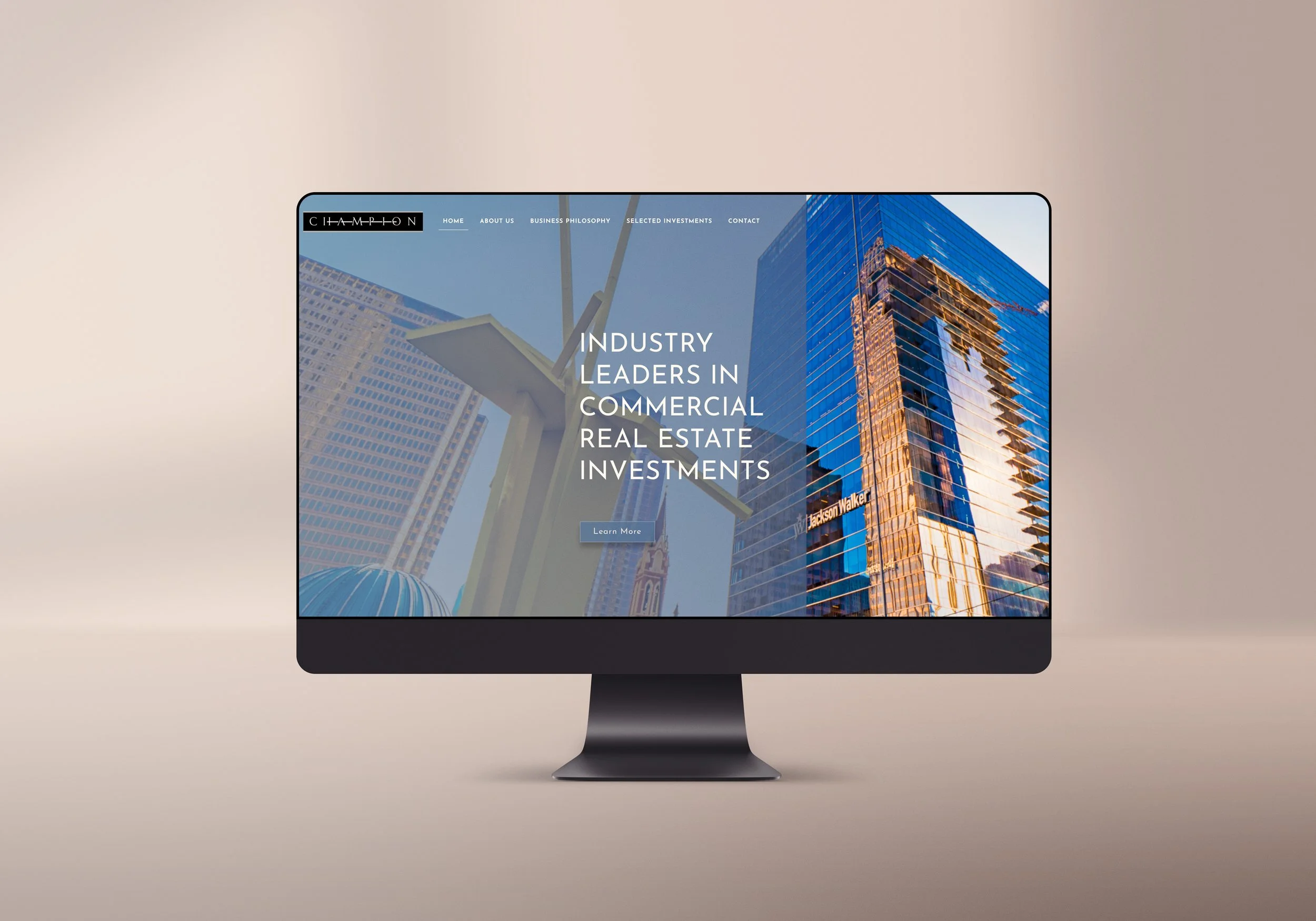 Computer monitor displaying a website for a commercial real estate investment company, with a cityscape and modern glass buildings in the background.