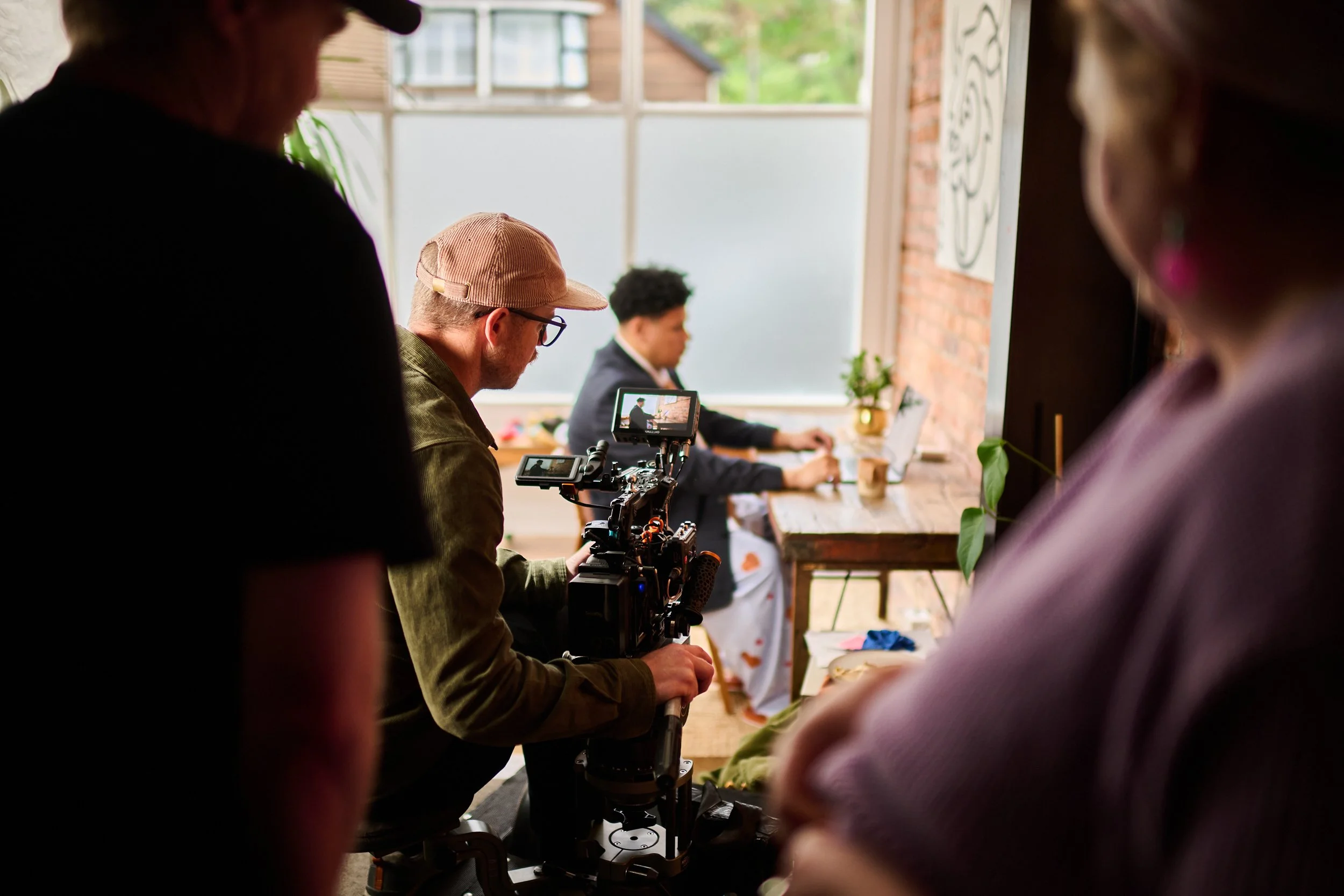 Camera operator Hamish McCormick filming the Statistics New Zealand commercial 'Data Helps Us Do' in a house