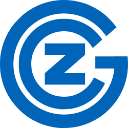 Logo des Grasshopper Clubs Zürich. Das Bild zeigt ein Logo mit einem blauen Kreis, darin der Buchstabe Z und G in blau, umgeben von konzentrischen Kreisen.
