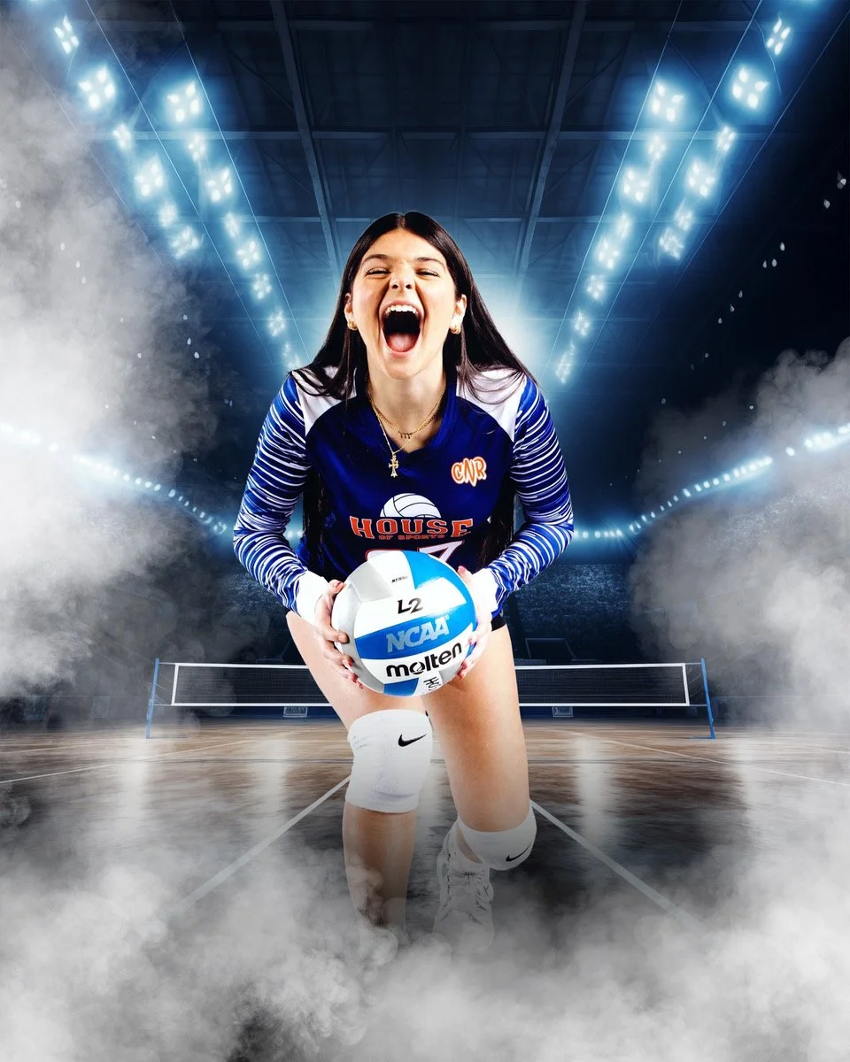 A young woman volleyball player in a blue and white uniform is on an indoor court, kneeling and holding a volleyball with both hands, with her mouth open as if cheering or shouting, on a smoky, dramatic background with bright stadium lights.