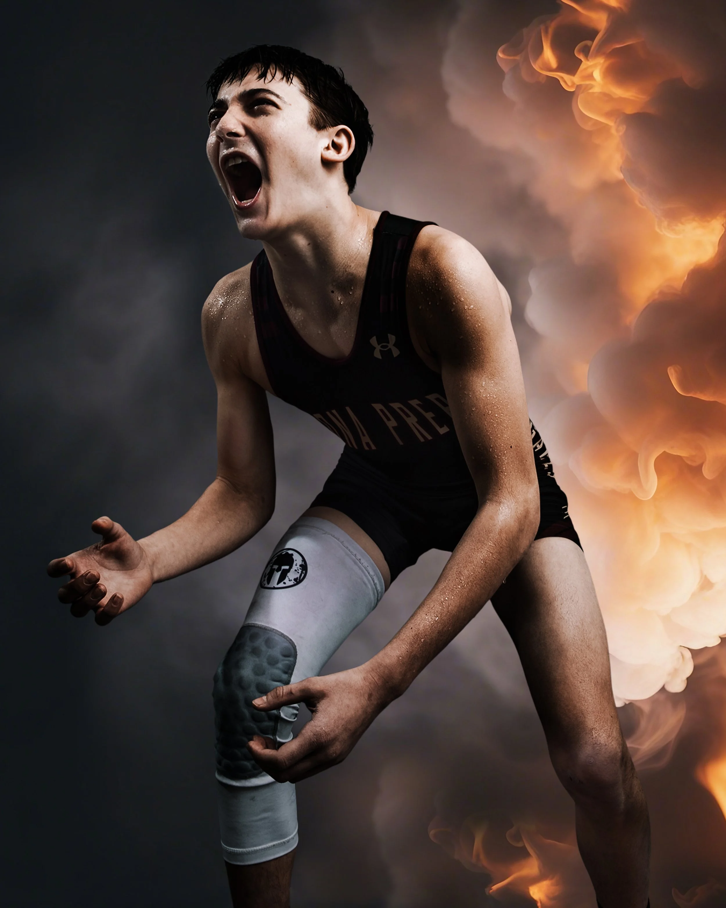 A young female athlete passionately cheering or shouting, wearing a black sports uniform with 'VA PREP' written on it and a gray knee brace, with a dramatic background of dark clouds and orange flames.
