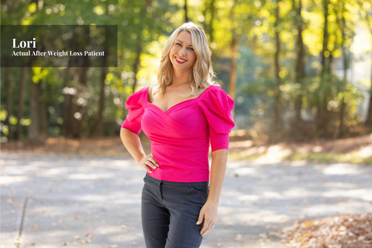 A woman with blonde hair smiling outside in a parking lot surrounded by trees, wearing a hot pink blouse with puffed sleeves and black pants.