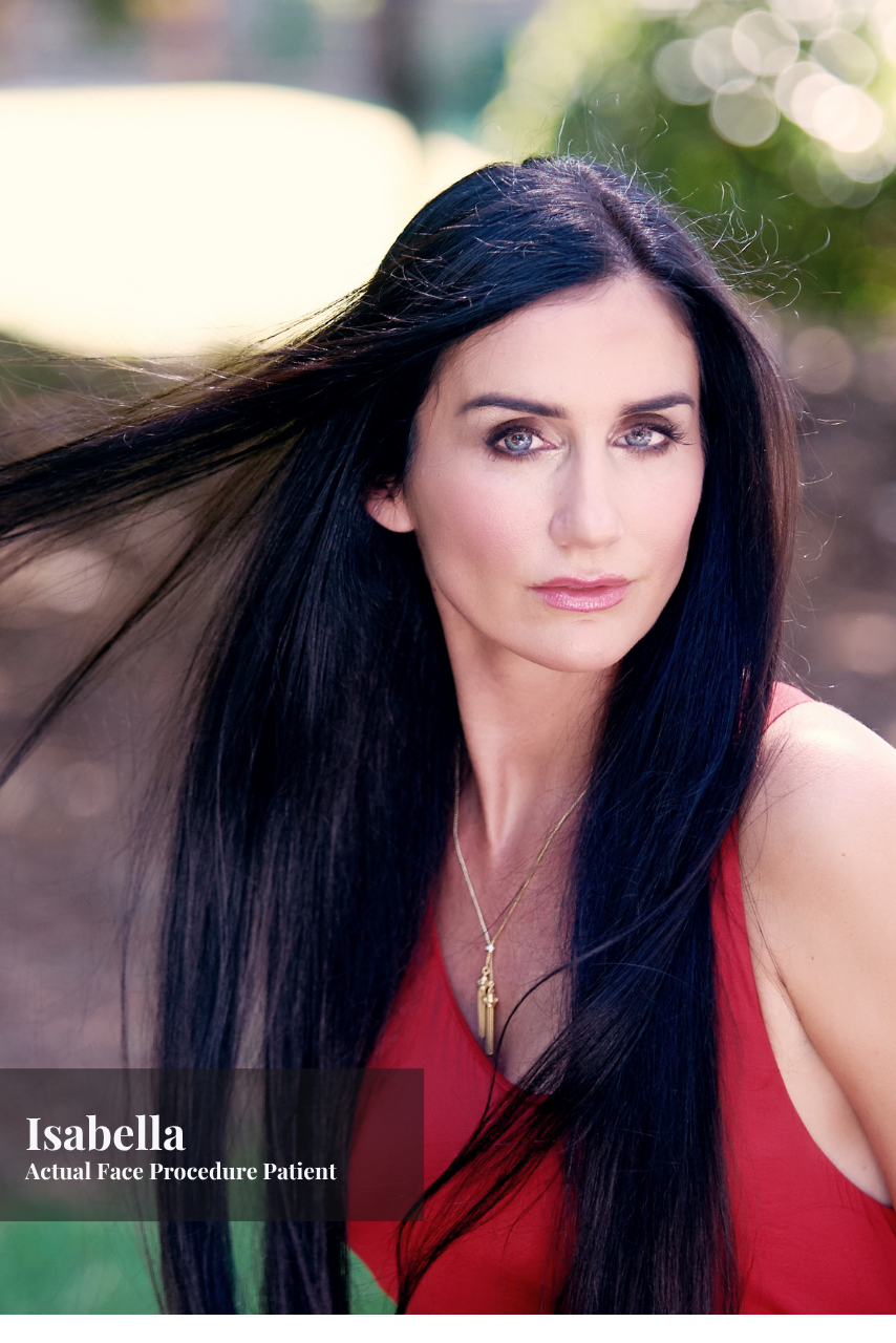 Portrait of a woman with long black hair in a red top outdoors with blurred background