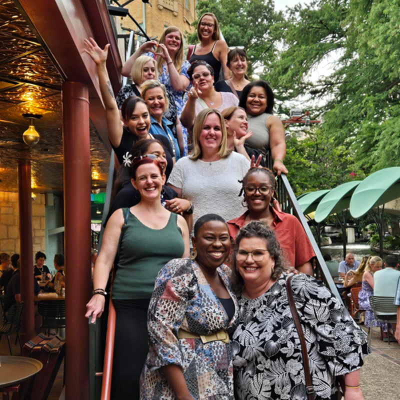A diverse group of Montessori teachers smiling
