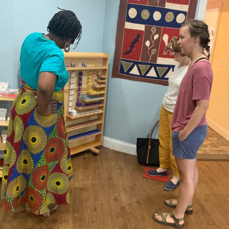 Three Montessori teachers looking at the bead cabinet