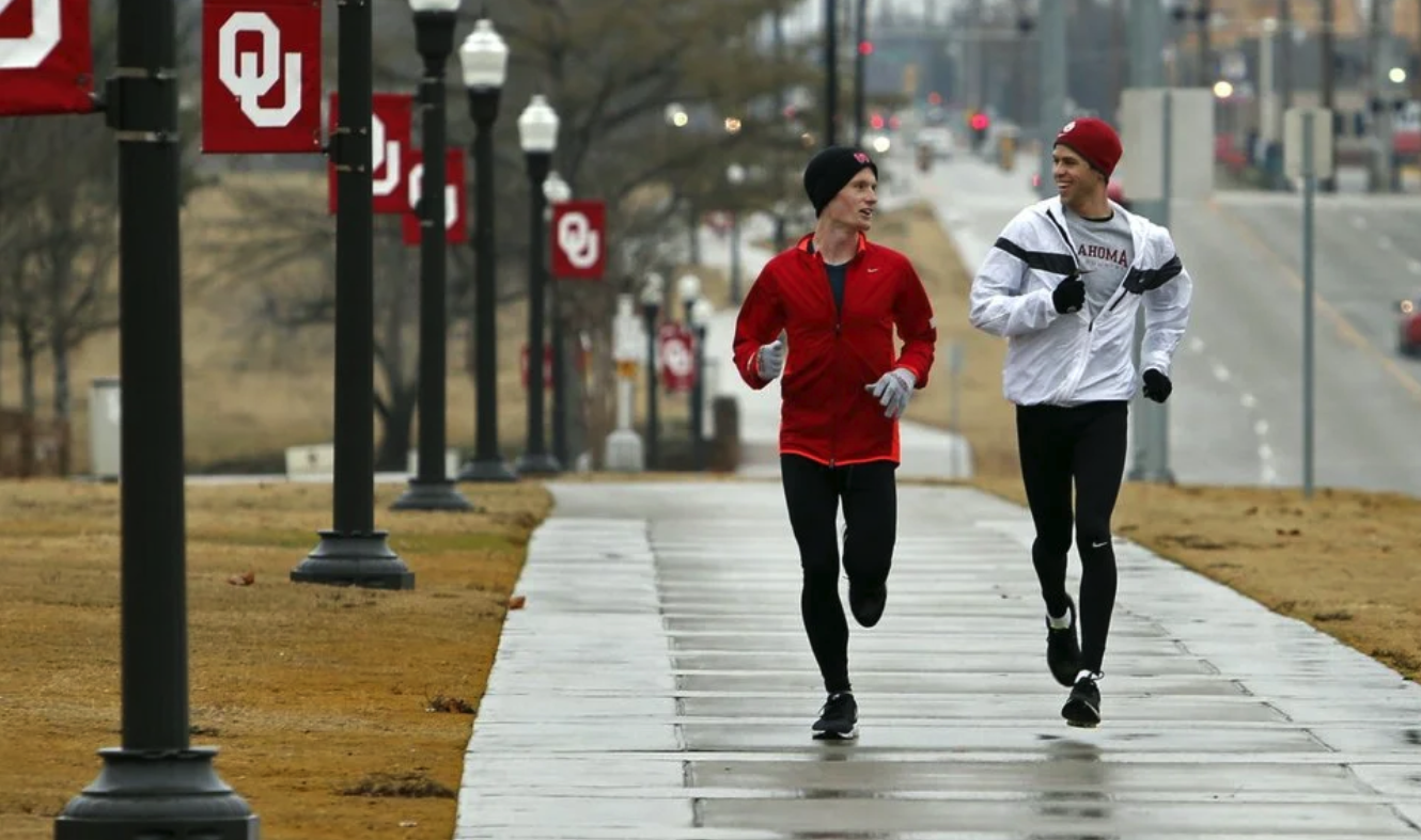 Two runners running together on a rainy day