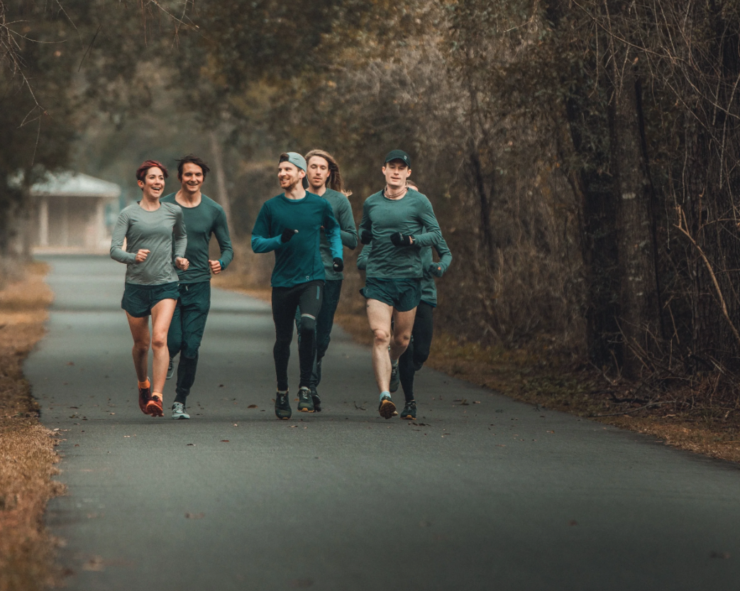 Coach Johnny and other runners running down a path