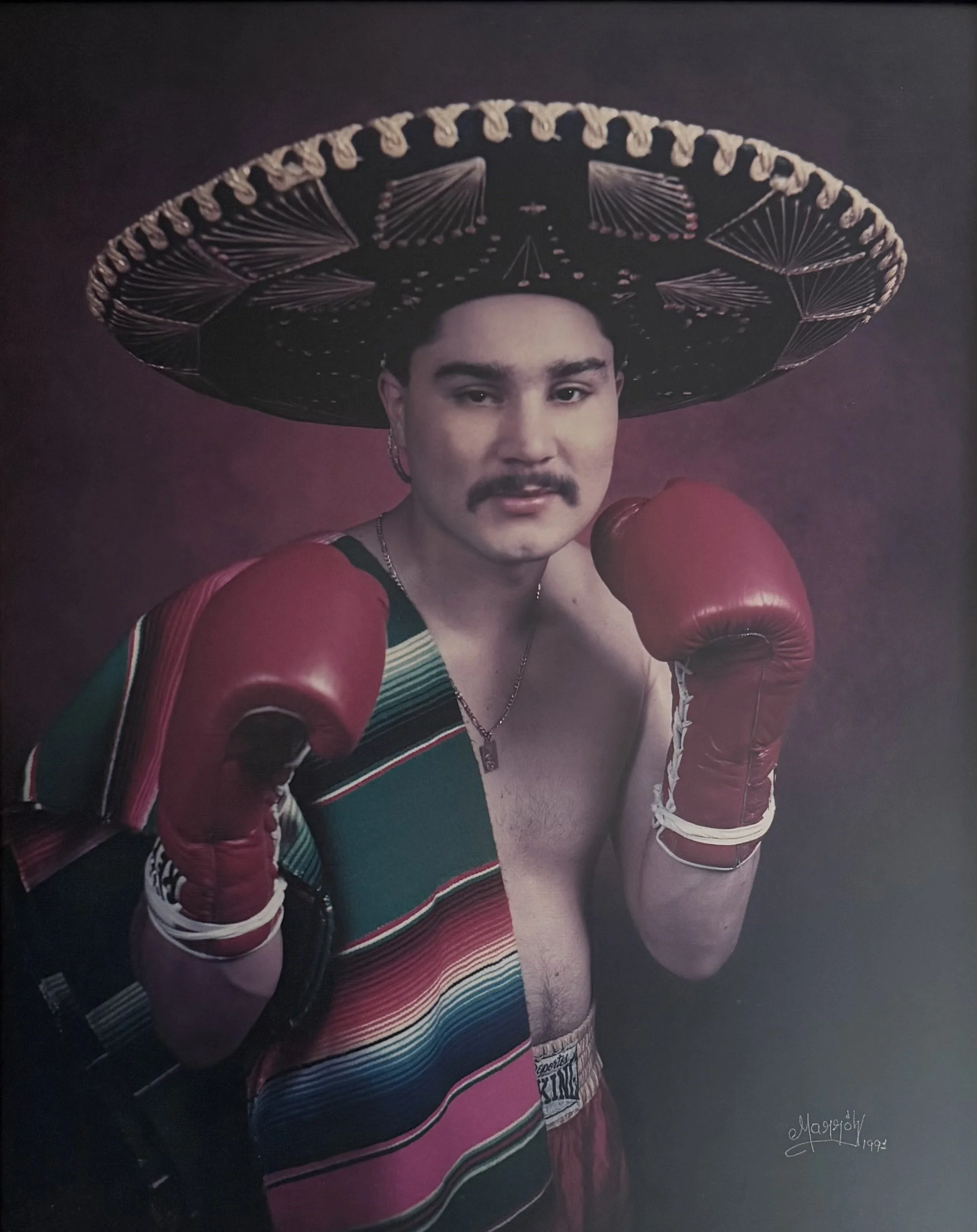 Professional fighter posing for camera with gloves raised in defensive position