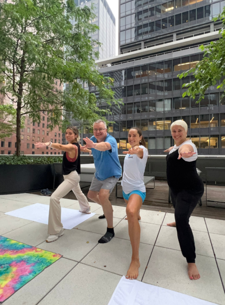 Daniela Burn teaching an outdoor rooftop yoga class in NYC.
