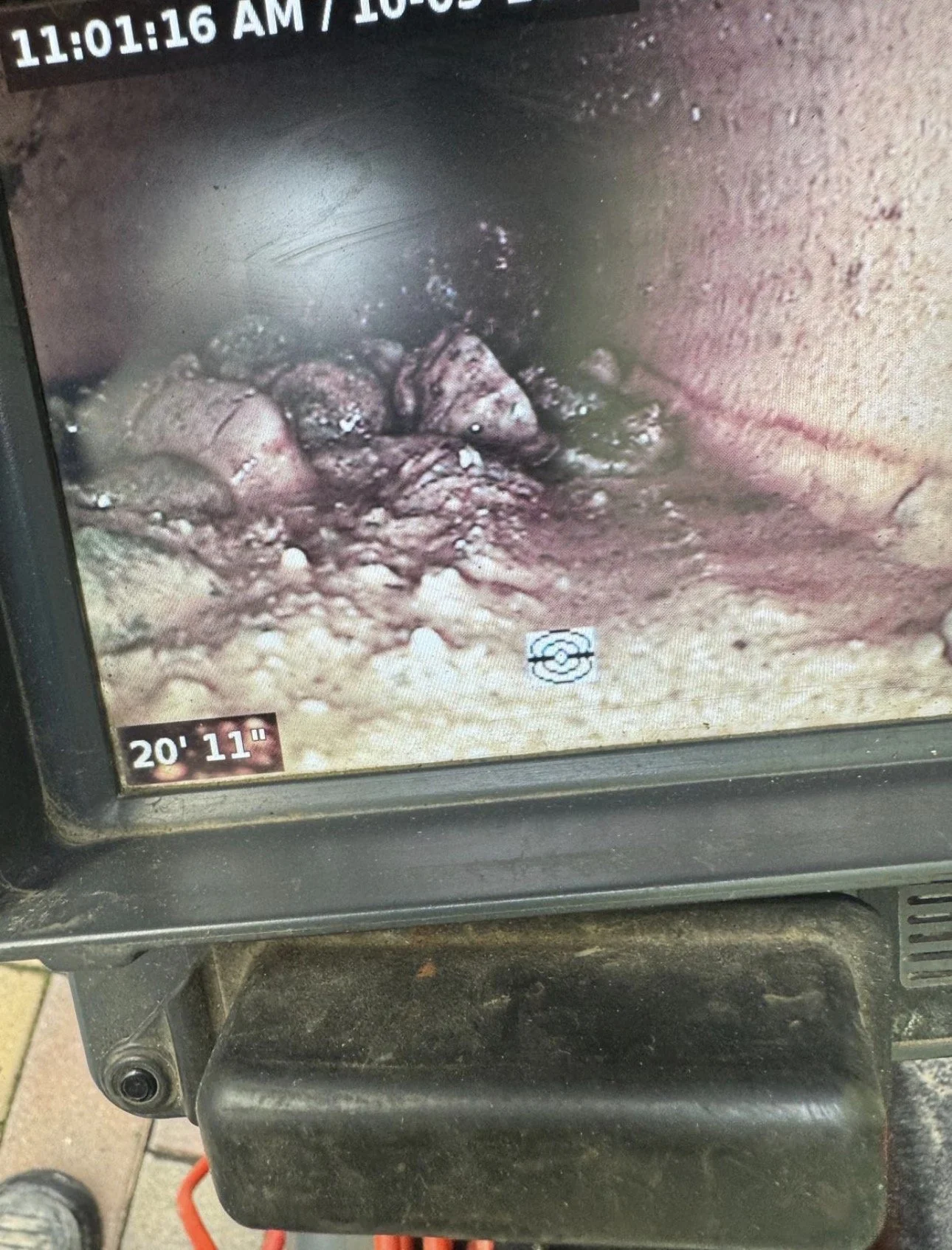 Close-up of an endoscopic view showing internal tissue with some irregular growths or lesions, captured on a screen with timestamp and camera details.