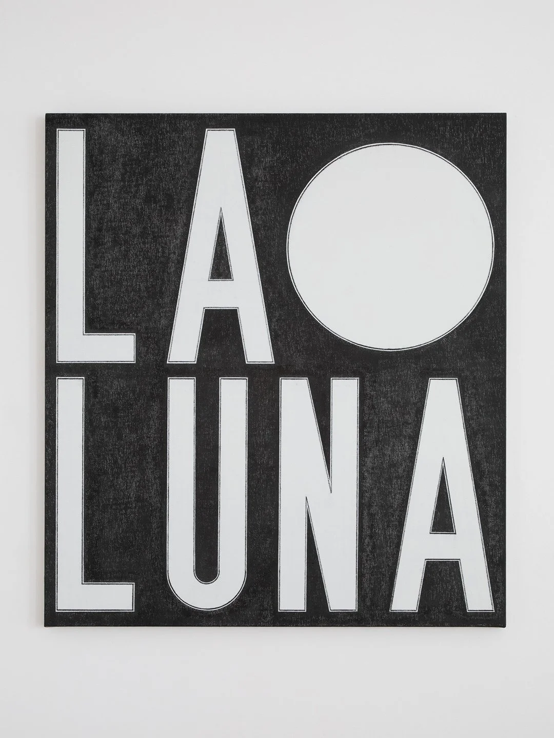 Black and white sign with the words "LA LU" and a large circle.