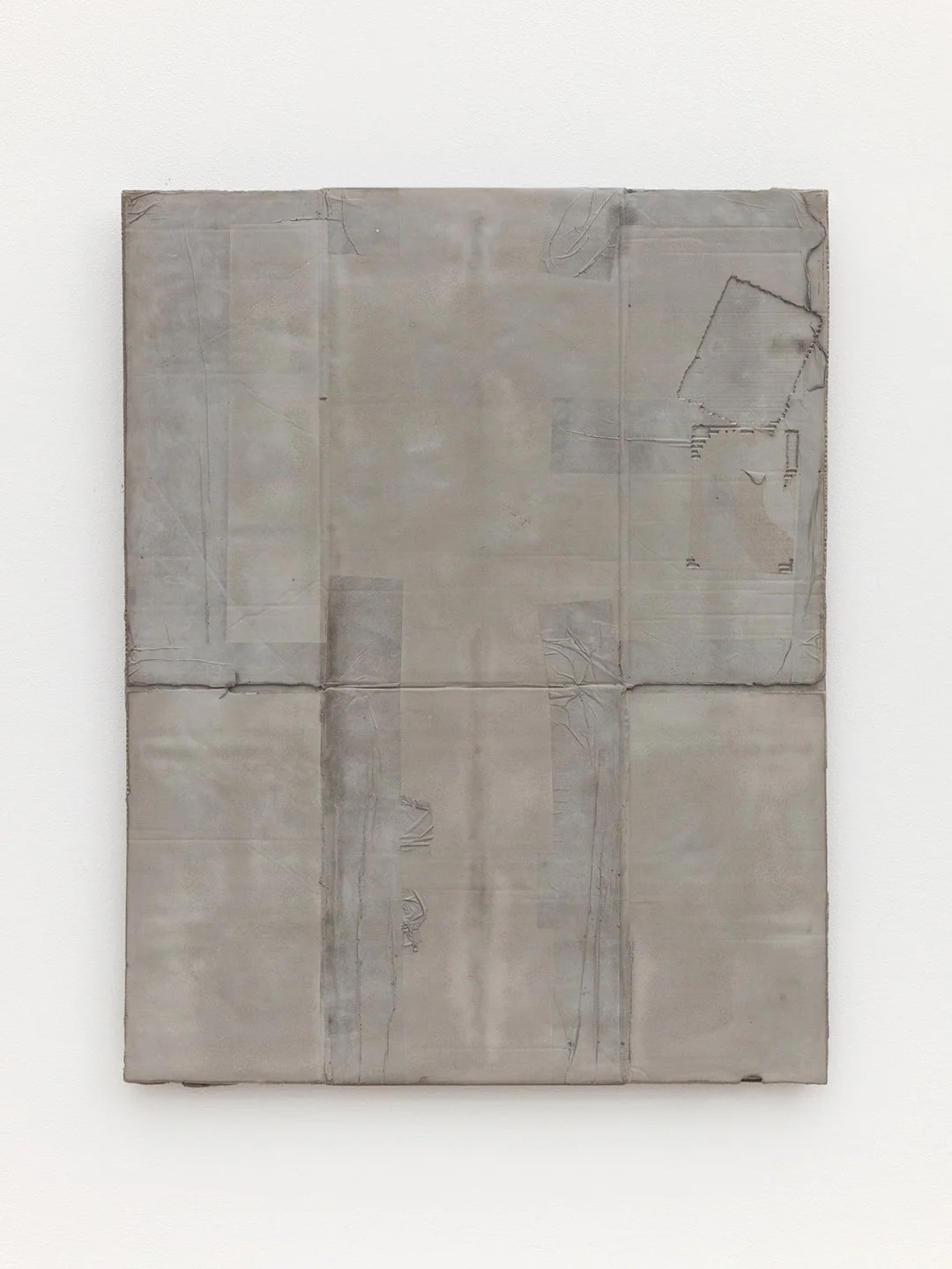 A minimalist abstract painting with a textured gray surface, featuring subtle line and shape details, hung on a white gallery wall.