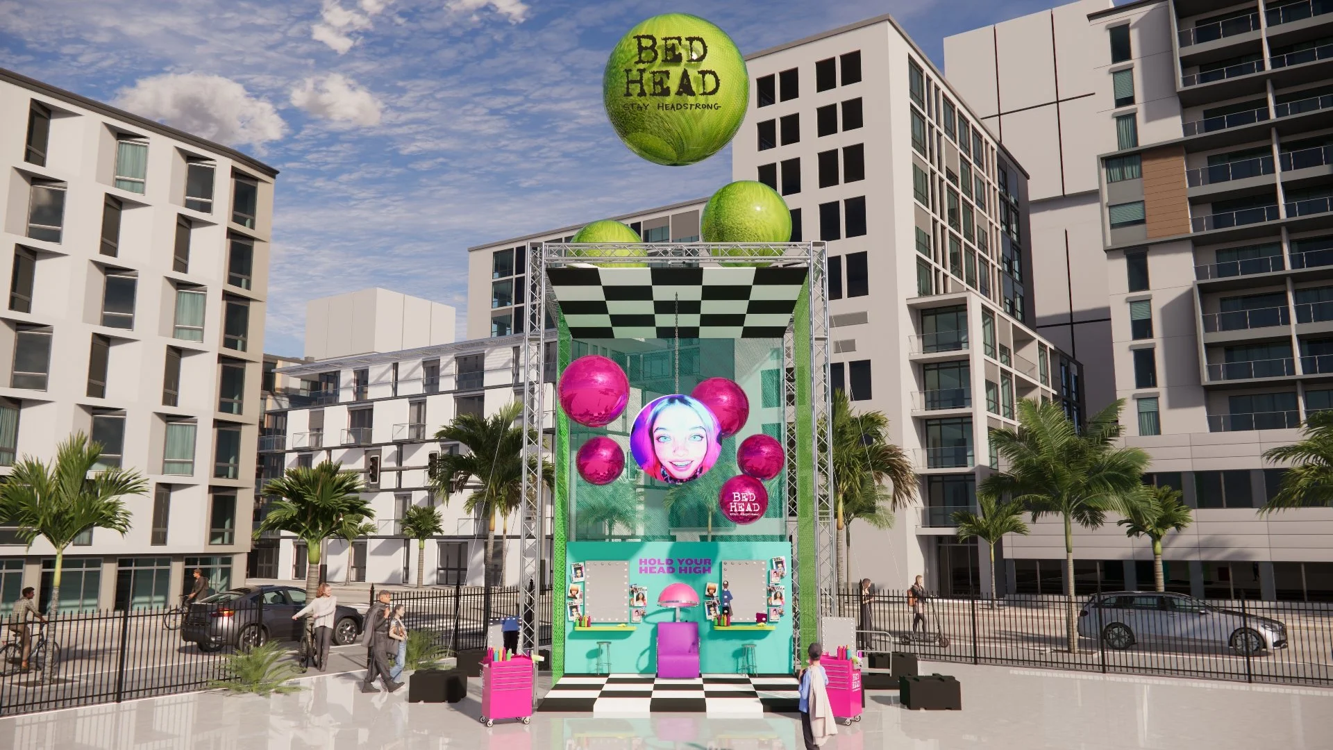 An outdoor event setup with colorful floating spheres, a large screen displaying a smiling girl's face, and a checkered stage with arcade-style game booths, surrounded by modern high-rise buildings and palm trees.