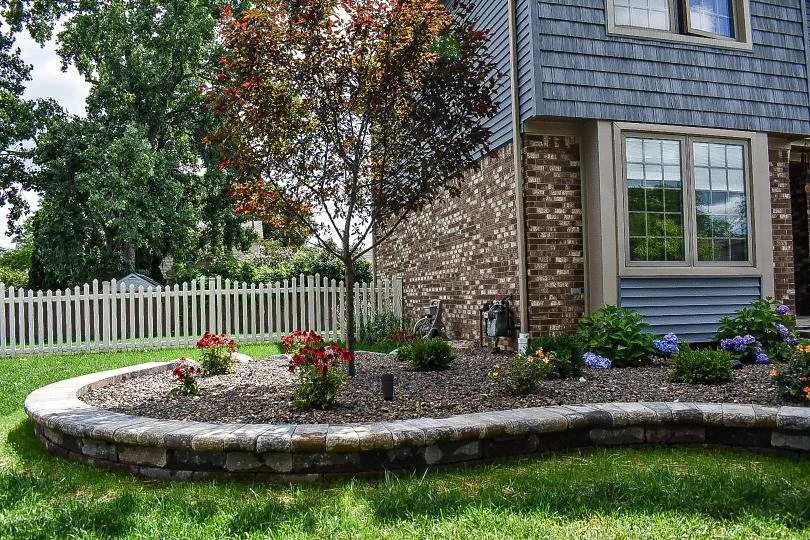 Decorative stone groundcover installation providing a clean, low-maintenance finish for front yard landscaping — GLC Lawn & Landscape