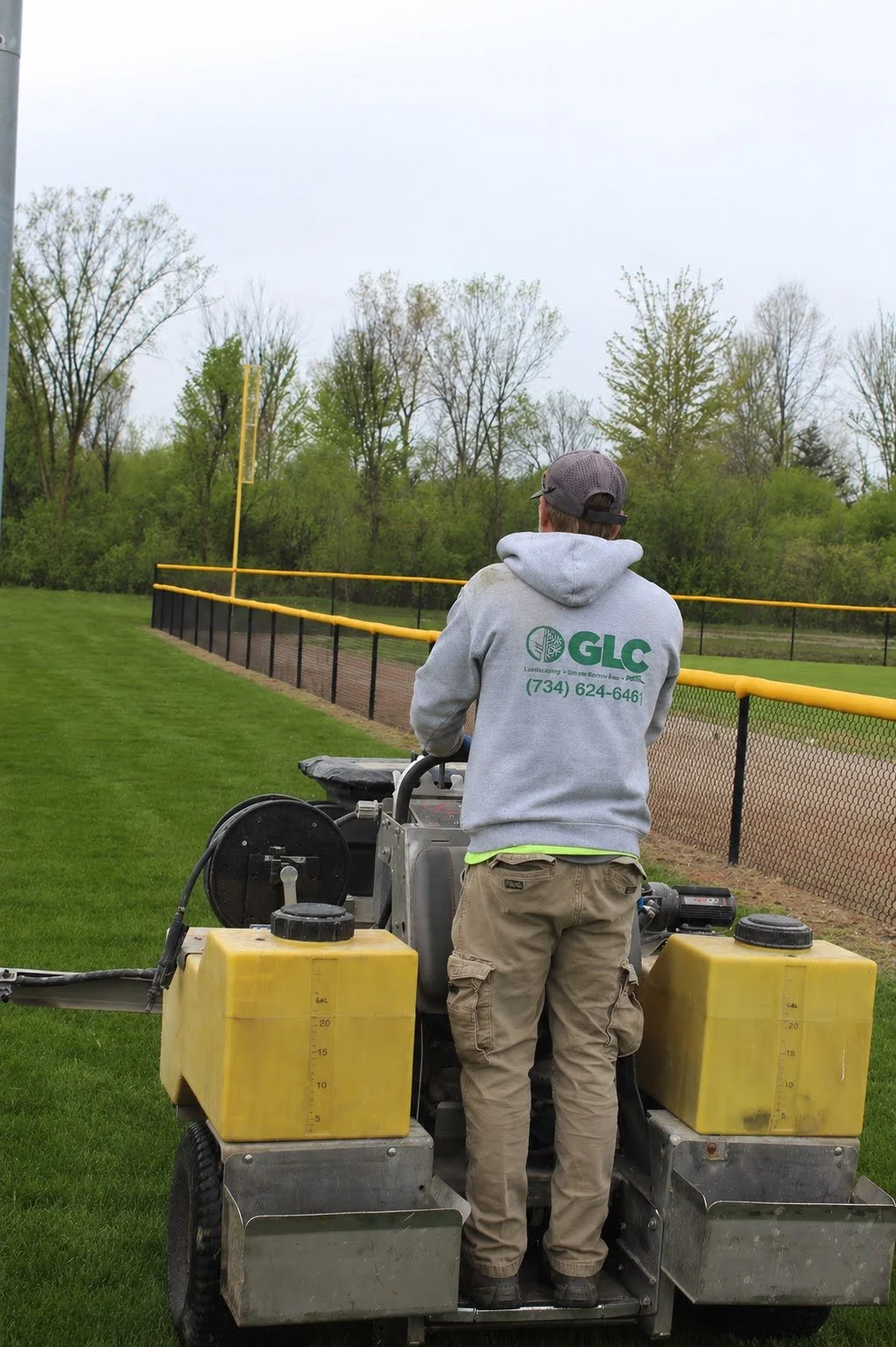 Hardscape crew fertilizing landscape in Monroe MI