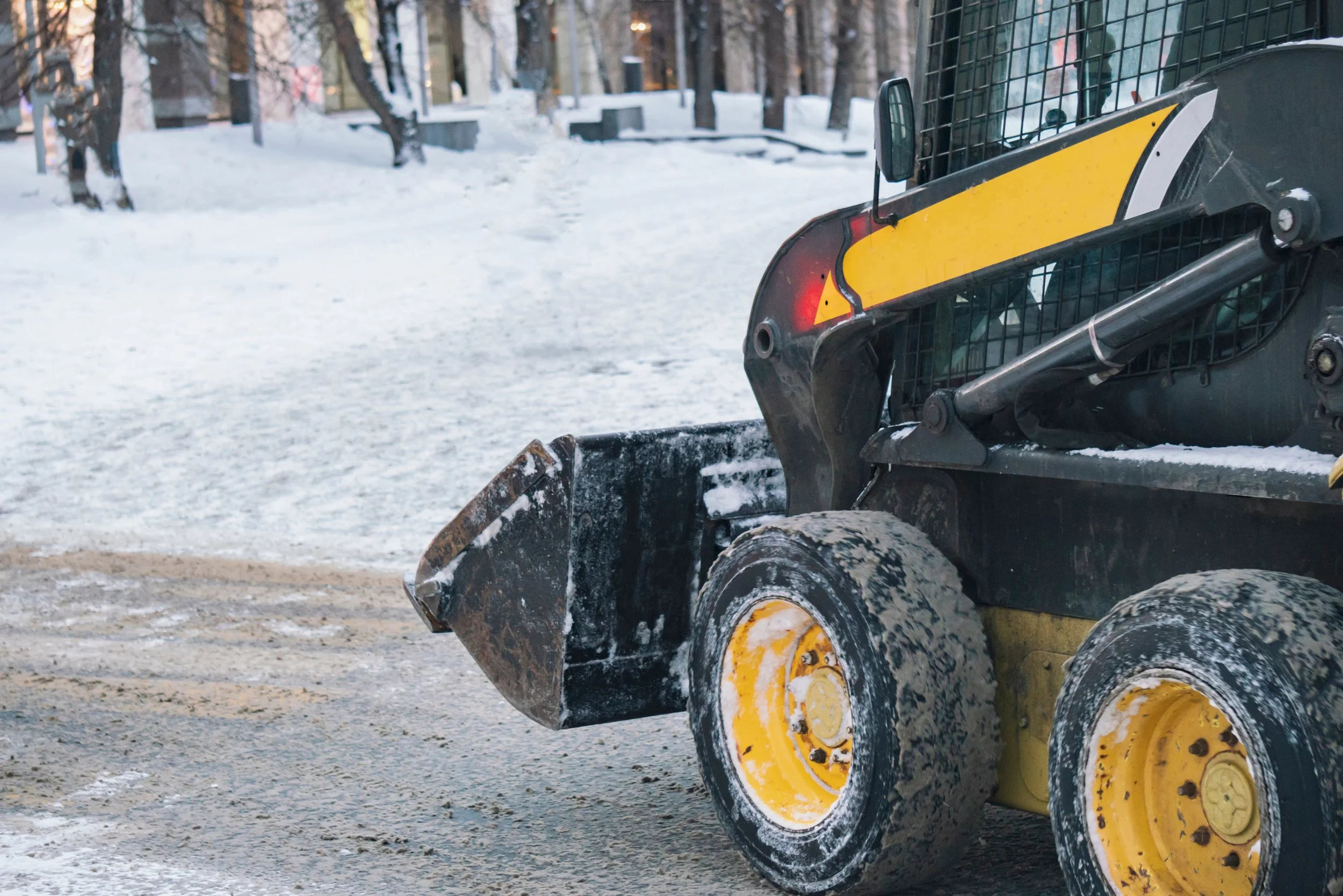 Commercial snow removal services clearing parking lots and walkways after winter snowfall. — GLC Landscaping & Pools