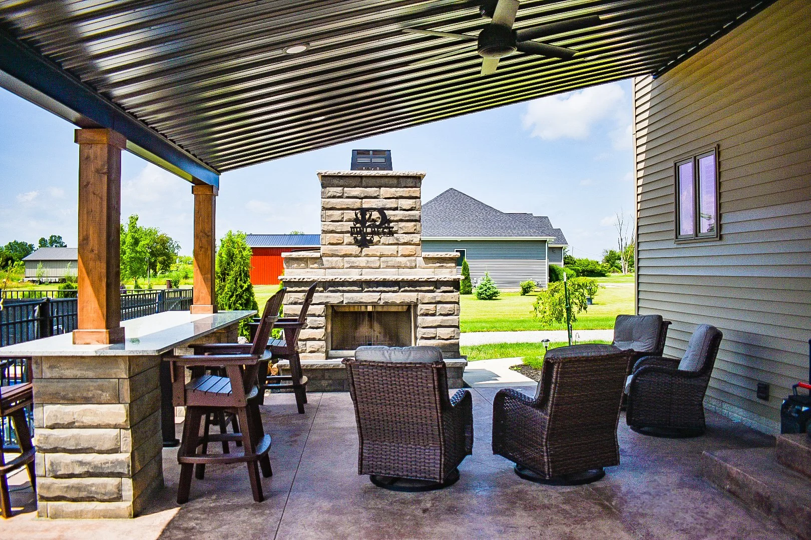 Outdoor living space with pergola, seating area, and fire feature. — GLC Landscaping & Pools
