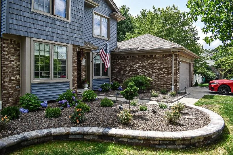 Curved retaining wall installation adding structure, dimension, and visual interest to a front yard landscape — GLC Lawn & Landscape