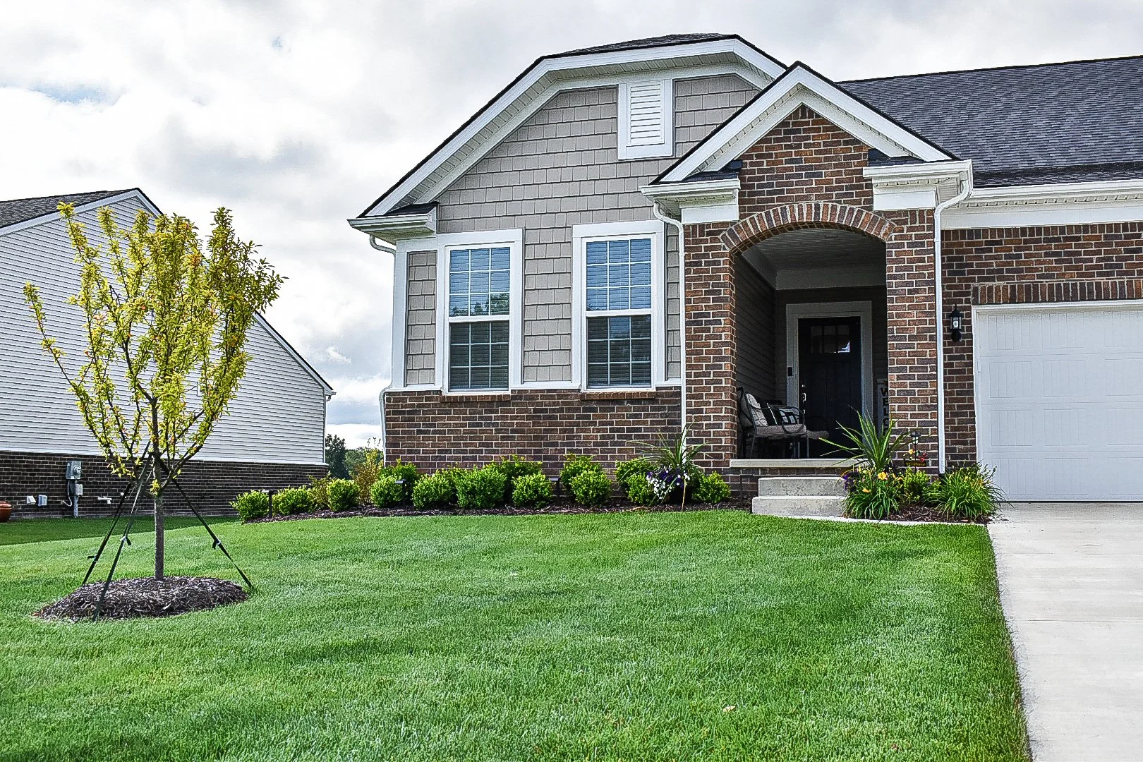 Decorative retaining wall and built-in seat wall construction integrated into a multi-level outdoor living design — GLC Lawn & Landscape