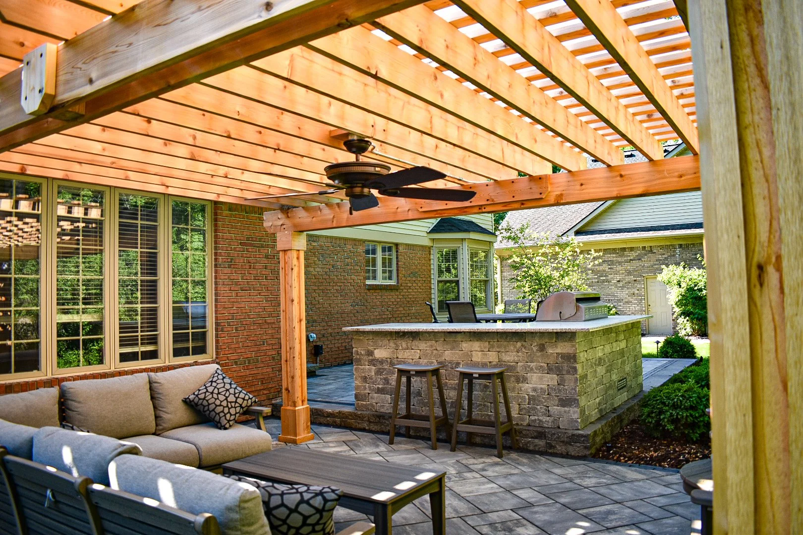 Large-format paver patio under custom wood pergola structure