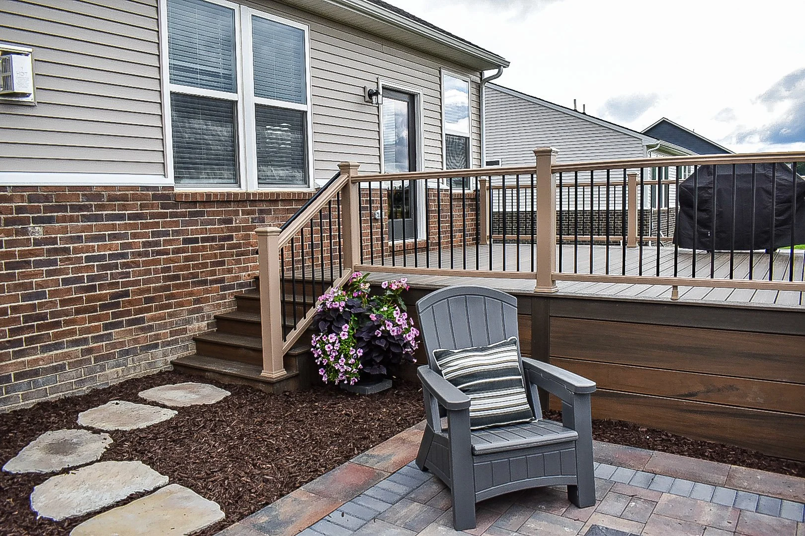 Gas fire pit installation serving as the focal point of a professionally designed backyard outdoor living space — GLC Lawn & Landscape