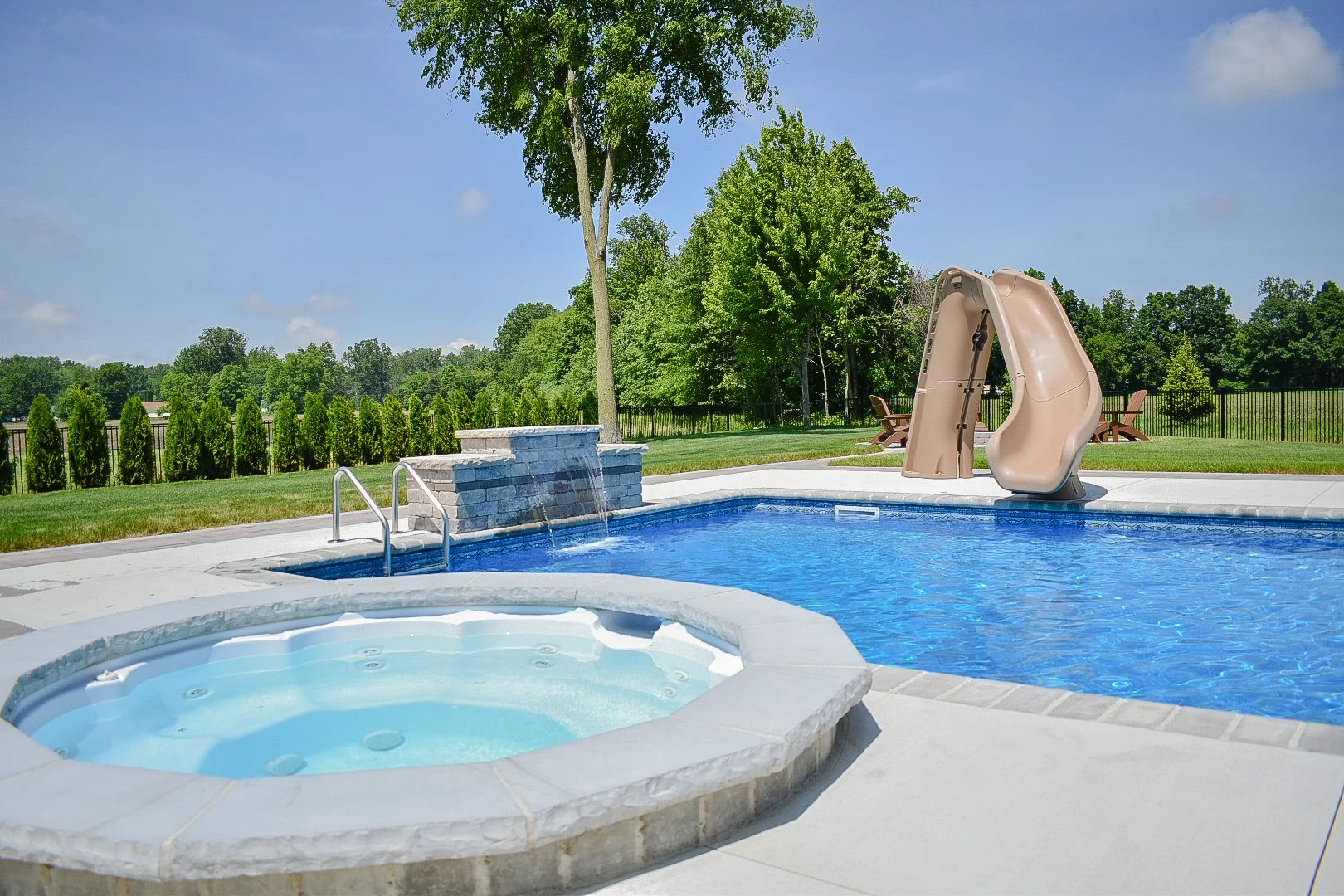 Fire pit lounge area construction designed for comfortable outdoor gatherings around a custom fire feature — GLC Lawn & Landscape
