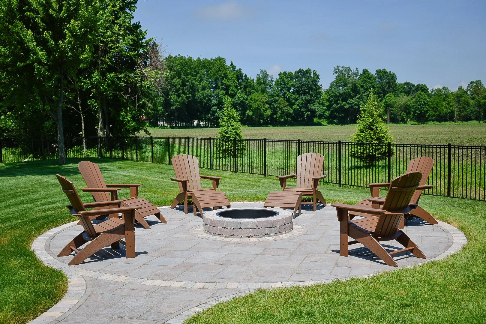 Raised water feature wall creating a dramatic focal point alongside a custom pool and spa design — GLC Lawn & Landscape