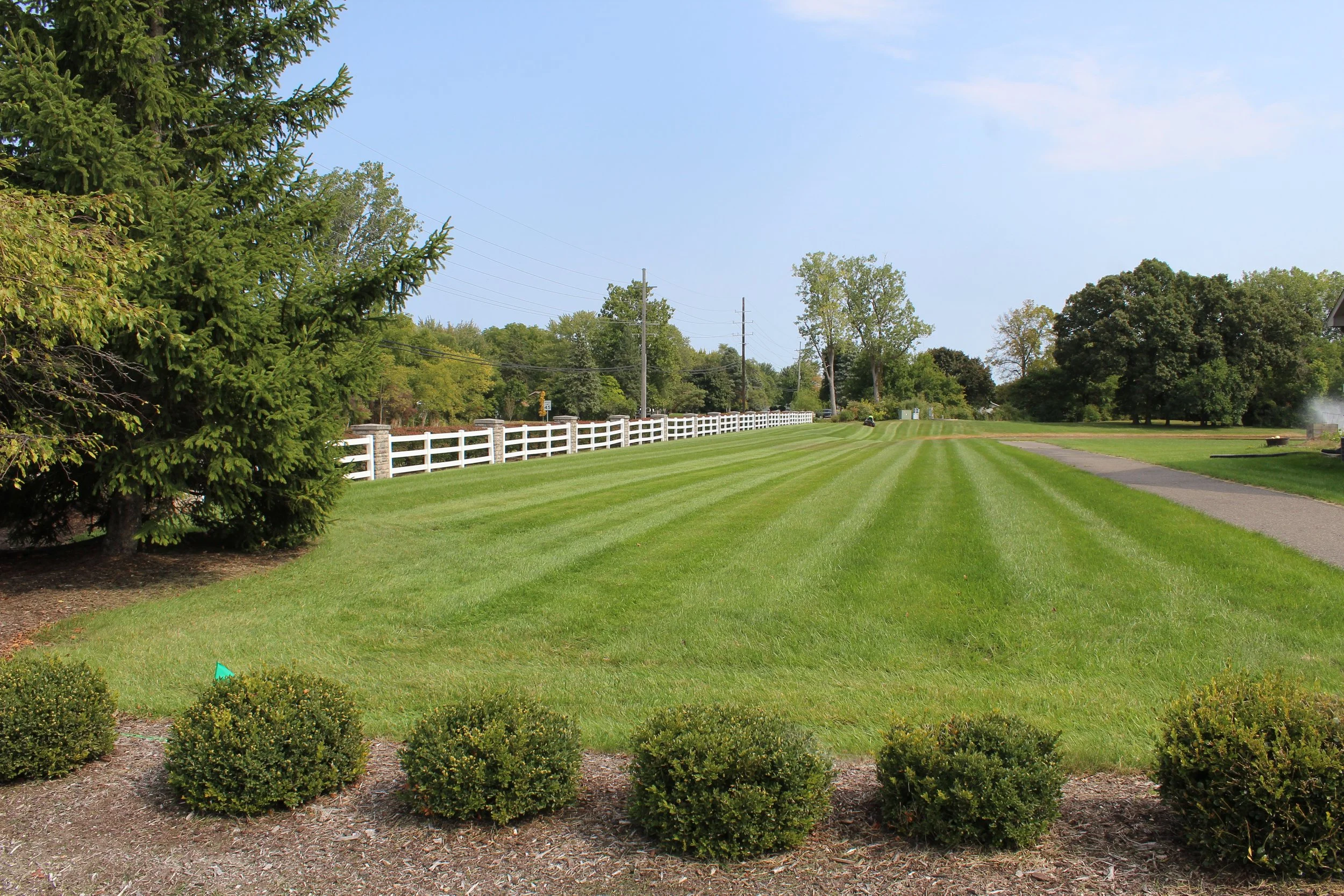 Landscape maintenance crew servicing multifamily property in New Boston MI